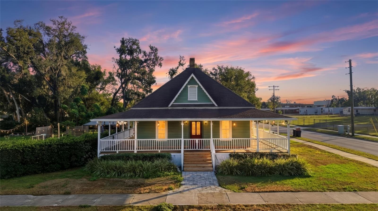 One or more photo(s) has been virtually staged. Welcome to this beautifully restored historic gem nestled in the heart of Dade City. This charming 3-bedroom, 3-bathroom home offers an ideal blend of timeless character and modern convenience. Set on a spacious corner lot with a large yard, this property features two inviting living spaces, an office, and a thoughtfully updated kitchen. Inside, you’ll find original hardwood floors, high ceilings, and elegant fireplaces in both the family room and dining room, plus a second fireplace in the primary bedroom for added warmth and ambiance. The primary suite also includes its own bathroom, walk-in closet, and a laundry room with space for extra storage and added functionality. A standout wrap-around porch provides the perfect place to unwind or entertain, while the backyard oasis features a stunning in-ground pool, paver patio, fire pit area, and gazebo. A one-car carport is attached to the side of the home which offers ample parking space for family and friends. This is a rare opportunity to own a piece of history with all the comforts of today. Do not miss this opportunity - Schedule you showing today!