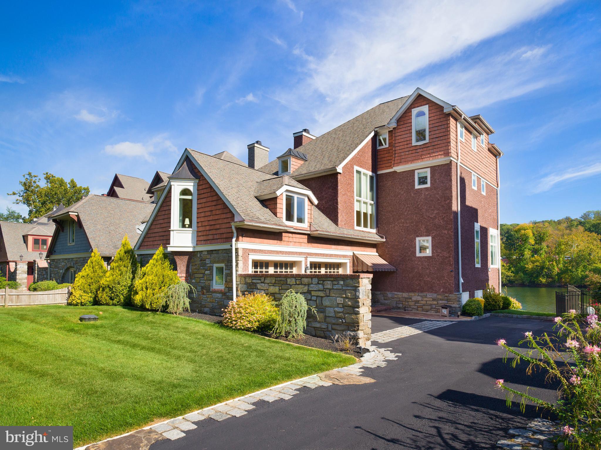 Riverfront Living Redefined in Gladwyne. Set directly on the Schuylkill River, this exceptional 4-bedroom, 4.5-bath home offers a lifestyle unlike any other on the Main Line—where mornings begin with sunlight glinting off the water and days unfold effortlessly kayaking, boating, water-skiing, wakeboarding, or simply relaxing along the river’s edge. Designed for those who crave connection to nature without sacrificing proximity to the city, this residence captures the rare serenity of waterfront living just minutes from Gladwyne Village and Center City Philadelphia.Inside, 10-foot ceilings, expansive windows, and gleaming hardwood floors create a sense of openness and light. The gourmet kitchen features floor-to-ceiling cabinetry, granite countertops, a large center island, and high-end stainless-steel appliances—perfectly suited for both quiet mornings and lively gatherings. The main living areas flow seamlessly to outdoor terraces and decks, framing stunning river views at every turn.Each bedroom is spacious and tranquil, with beautifully finished baths throughout. A dedicated boat room provides convenience and storage, complementing the private dock that anchors this true riverfront retreat.Few homes offer such an intimate connection to the water—and even fewer combine it with timeless architecture, modern comfort, and the prestige of a Gladwyne address.