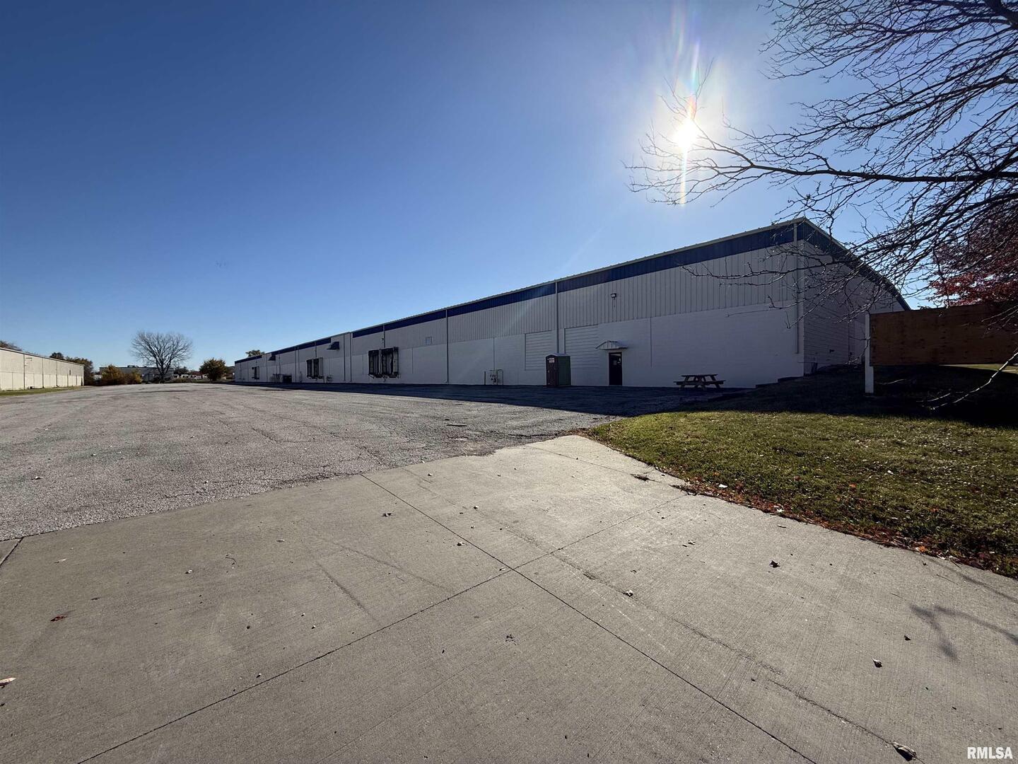 This industrial facility offers approximately 120,000 square feet of functional warehouse and distribution space in Rock Island's industrial district. The building provides an approximate 22-foot clear height with a wide, efficient column layout of approximability 38 feet by 50 feet. Includes a wet sprinkler system and the warehouse is heated with a Make-Up Air (MUA) system. Motion-activated LED lighting, 3-phase power, and paved truck access areas support a wide range of industrial operations. The property offers strong connectivity with immediate access to the Milan Beltway and close proximity to Interstates 280, 74, and 88. Loading includes approximately six dock-high doors measuring about 10' x 9' and one similar overhead drive-in door, along with roughly eight man doors throughout the building. An existing office area can be updated or rebuilt depending on user needs. With its large footprint, infrastructure, and strategic location, this property is ideal for owner-users or investors seeking clean and functional industrial space in the Quad Cities.
