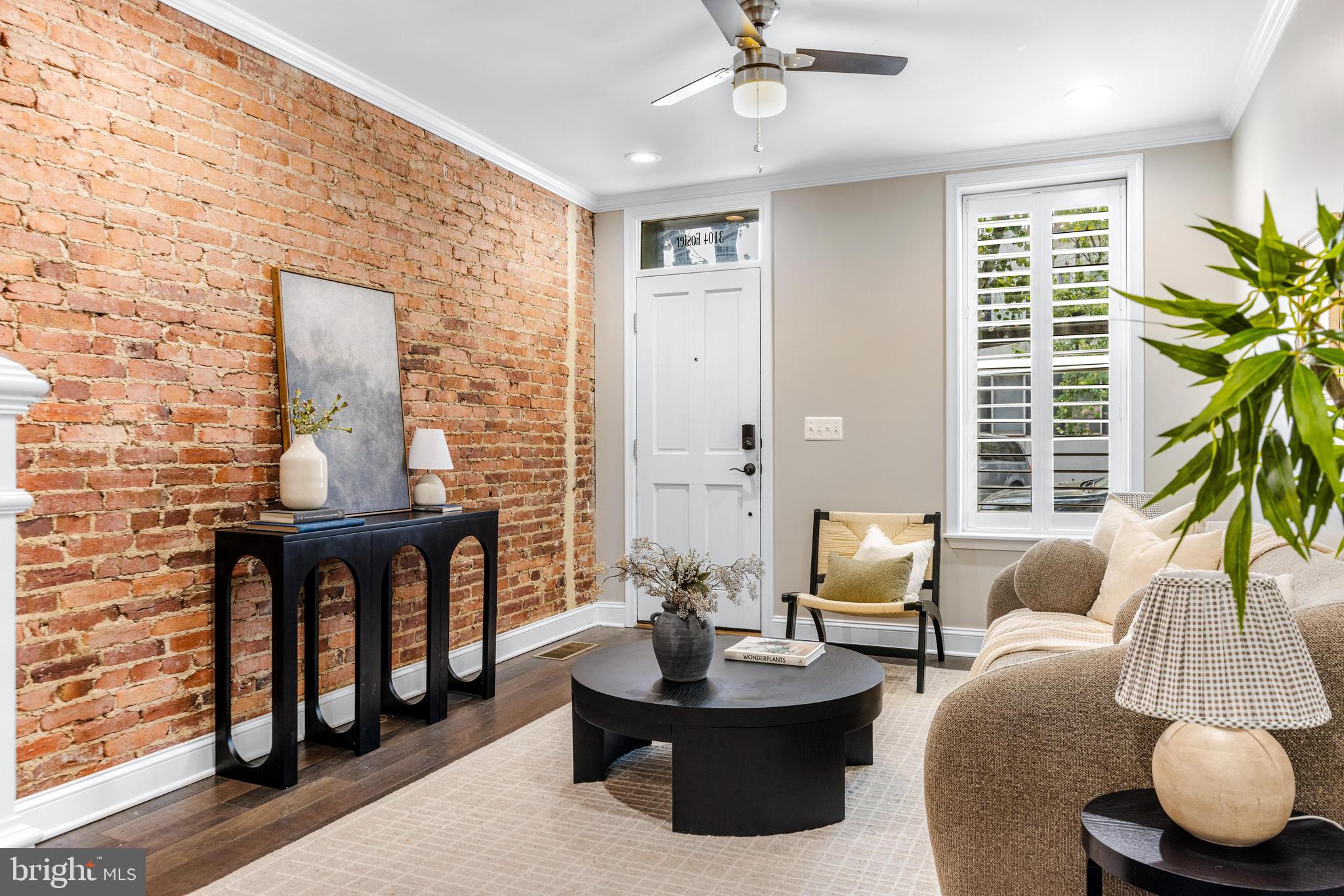 Available for immediate occupancy - classic Baltimore row home offering 2 off street parking spots with an A+ location where you can head straight out your door down to Canton Waterfront or up to Patterson Park. Inside you will immediately notice the classic exposed brick on main level, hardwood floors across main & upper level and a fresh coat of paint. The kitchen is the main event in this house - with a large island with sink & dishwasher, abundance of beautiful white cabinetry, stainless steel appliances, light grey and white granite countertops and gorgeous grey tile backsplash. Continuing past kitchen is a convenient main level 1/2 bathroom and exterior door leading out to an actual fenced in "backyard" / patio and behind the fence, you'll find not 1 parking spot but 2 actual parking spots - this is a rare find in Baltimore City! Upstairs offers 2 bedrooms + 2 full bathrooms, downstairs offer 2 more bedrooms + 1 full bathroom. The upper level hallways has a laundry closet with side by side washer / dryer and hallway door leads to exterior steps to a must have Baltimore City rooftop deck with city skyline views.