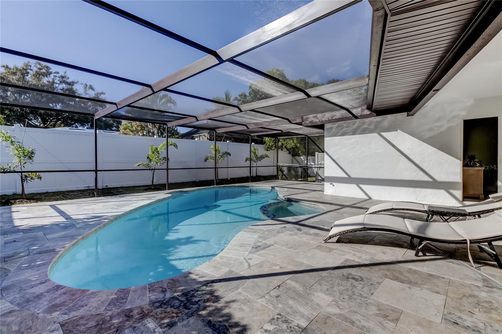 Welcome to your dream oasis! This fully updated 4-bedroom, 2-bathroom pool house is a true gem, designed with an eye for detail and a focus on modern living. NOT in a Flood zone!As you step inside, you'll be greeted by a bright and open layout that seamlessly connects the living, dining, and kitchen areas—perfect for both relaxing and entertaining. The stylish shaker cabinets provide ample storage and a chic aesthetic, while stainless steel appliances and exquisite quartz countertops elevate the kitchen to culinary heaven. The bathrooms have also been tastefully updated, featuring luxurious Cambria quartz countertops that add an extra touch of elegance. Fresh paint both inside and outside gives this home a new, vibrant feel, complemented by solid wood one-panel doors that add character and warmth. Luxury Italian porcelain tiles flow throughout entire home, adding sophistication and durability to every room. Step outside and experience the allure of Florida living by your own sparkling pool! The travertine decking enhances your outdoor space, making it an ideal area for sunbathing, swimming, or hosting family gatherings. This immaculately designed home is a perfect blend of style and functionality—don’t miss the opportunity to make it yours! Whether you’re looking to relax by the pool or entertain guests, this property has it all. Schedule your viewing today and embrace the Florida lifestyle you’ve always dreamed of!