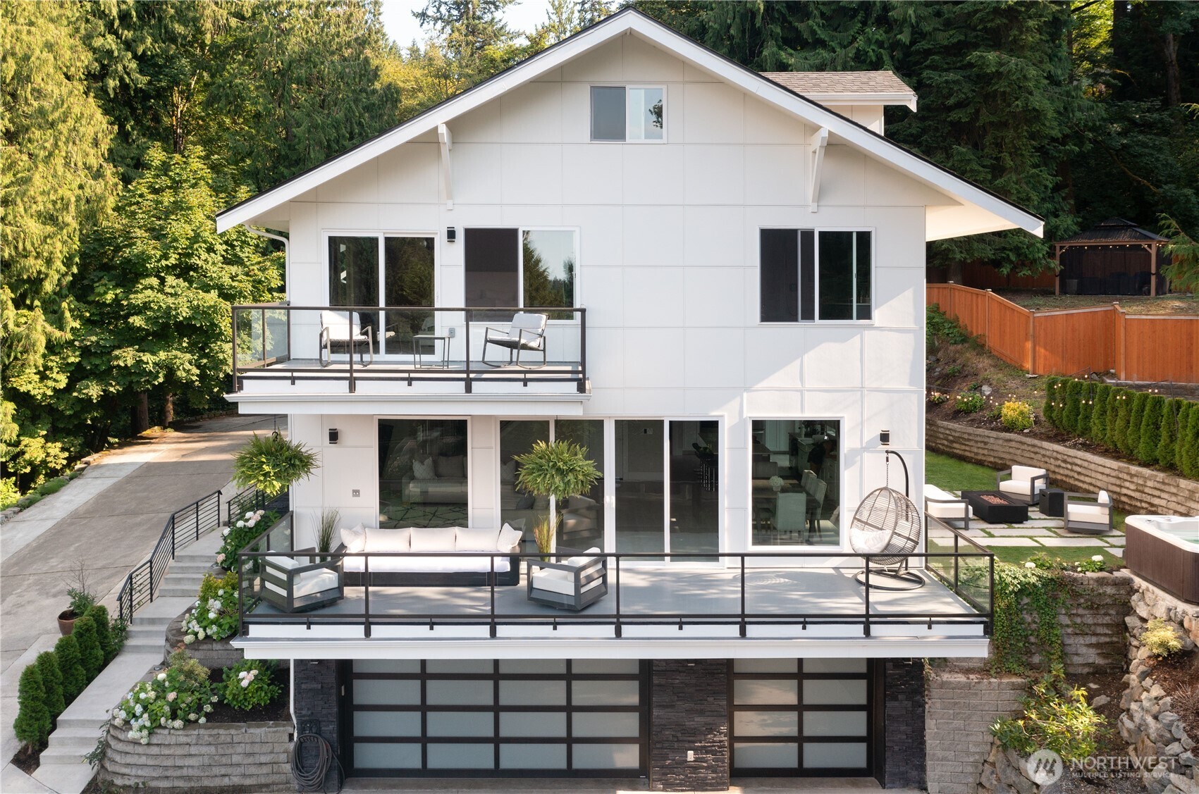 Sitting on top of the hill, on a private road, you will find this absolutely grand 4300 sq. ft. modern home. Custom built-in 2020. Main level w/ 9 ft. ceilings with a truly open concept from kitchen to the dining room, great room, and 4-panel sliding door that opens up to the impressive deck (w/in-ceiling heaters), making this a seamless indoor/outdoor entertaining space. Gorgeous kitchen with white cabinets, quartz countertops, and GE stainless steel appliances. Oversized windows in the great room/dining for maximum natural light. The Grand staircase takes you to the upper level. Primary bedroom with its own deck. Beautiful territorial views of Sammamish River Valley. Oversized 3 car garage. Burke Gilman trail just down the street.