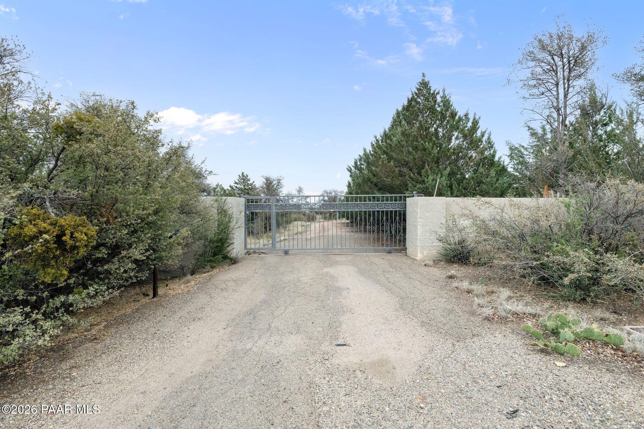 Discover a rare opportunity to own a truly exceptional property in a highly desirable location adjacent to Prescott Lakes. Zoned SF-9, this expansive 18+ acre offering consists of three parcels w/ gently rolling topography & breathtaking views overlooking downtown Prescott. This unique homestead presents incredible potential for investors, developers, or those seeking a private estate. Whether you choose to revitalize the existing structures or envision a new subdivision, the possibilities are extensive. The main residence spans 4,618 sq. ft & features 6 bed, 3 bath, including an upper-level suite complete w/ a kitchenette, ideal for multi-generational living or guest accommodations. An additional 2,381 sq. ft. outbuilding includes 3 apartment units and caretaker's residence.While currently in need of restoration, the structure offers solid foundational elements, w/ existing electricity, plumbing, & septic systems already in place, making it a prime candidate for redevelopment into rental units, guest quarters, or a future community clubhouse. Property has two existing wells w/ 2 ponds that could be restored or re-designed. With its combination of size, zoning, location, & panoramic views, this property represents a rare & versatile investment opportunity in the heart of Prescott.Sale includes additional parcels include 116-18-066E and 116-18-080