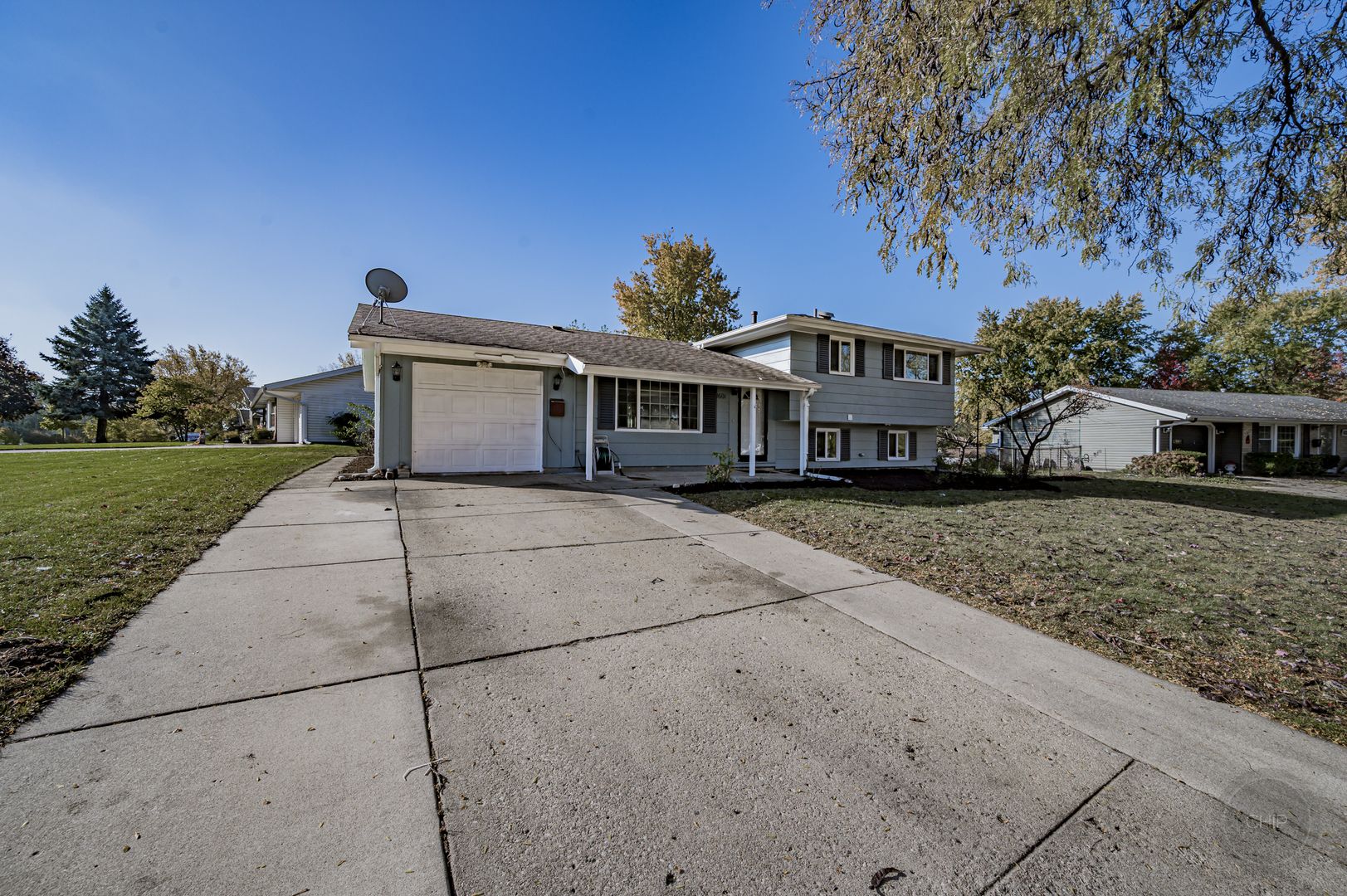 Updated and meticulously maintained split level home ready for new owners! This amazing property sits on an oversized corner lot in a quiet subdivision. Professionally landscaped yard and large front porch greet you as you pull in. Upon entry you will notice hardwood  floors, updated can lighting, oversized windows to allow tons of natural light. Leading into the kitchen, the stainless steel  appliances have all been updated most noticeably, the range hood in October 2025. If you need even more space, the walk out lower level english basement features marble tile and a sliding glass door leading to your patio and private backyard oasis. Follow the freshly painted steps up to find a FENCED yard filled with numerous fruit trees that will give you an abundance to last you all through the season. The lower level also features a full bathroom, and large laundry room with NEW laundry sink 2025 and newer washer and dryer! BRAND NEW FURNACE AND A/C REPLACED IN 2025. Upstairs features all hardwood flooring in three bedrooms, can lights and Solid wood 6 panel doors. Updated bathroom with NEW vanity! Home also features updated windows, newer roof. Perfectly located in the heart of schaumburg close to expressways, shopping and so much more!