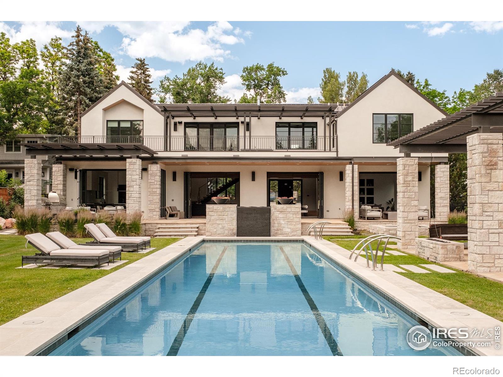 Unparalleled luxury in the heart of Boulder manifests as an architectural gem on a coveted 3/4 acre. From breathtaking views of the Flatirons and Mt. Sanitas, to spaces meticulously curated for effortless entertaining, this custom-built masterpiece redefines elevated living in every remarkably crafted detail. Natural light floods the open-concept entertainer's layout on the main floor through vast floor-to-ceiling windows & doors, illuminating a gourmet kitchen outfitted with custom cabinetry, a caterer's pantry and exquisite finishes. Seamless indoor-outdoor connectivity beckons residents into the pinnacle of resort-style ambience with a 75 ' long saline swimming pool, in-ground hot tub and stylish pool house. An elegantly appointed apartment above the garage wing offers a private retreat for guests or extended stays. With direct access to Boulder's open space trails and an unmatched blend of design, technology and natural beauty, this estate is a rare offering in a sought-after location.