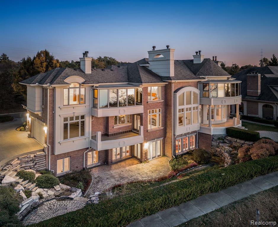 Experience unmatched luxury and privacy in this stunning estate, located in a prestigious gated community on All-Sports Orchard Lake. Situated in the highly acclaimed Bloomfield Hills School District, this nearly 9,000 sq ft home blends timeless elegance with modern comfort and incredible lakefront views. East-facing to capture beautiful sunsets and natural light, it feels like a private retreat. A grand double-door entry opens to a soaring two-story foyer with heated marble floors and a dazzling Baccarat crystal chandelier. The richly finished library includes a full bath and elevator access—ideal for work or relaxation. The formal dining room features a mosaic dome and another Baccarat chandelier, creating an unforgettable entertaining space. The chef’s kitchen offers custom cabinetry, a large island, Thermador appliances, Sub-Zero refrigeration, and a walk-in pantry. The expansive double-height family room, with dual fireplace and lake views, is perfect for gatherings. The elegant living room includes a tray ceiling and wet bar overlooking the water. The luxurious primary suite offers sweeping lake views, a fireplace, wet bar, elevator access, custom walk-in closet, and a spa-inspired bath with Jacuzzi tub and steam shower. Upstairs, two en-suite bedrooms boast private balconies and stunning lake vistas. The walkout lower level includes a second full kitchen, stylish bar, media room, family room, storage, and a guest bedroom with en-suite bath. A private tunnel leads from the backyard to the lake, where you can have your own private dock. Priced well below the $6M+ duplication cost, this estate is an incredible value and a rare opportunity to add your personal touches and make it your own. I.D.R.B.N.G.