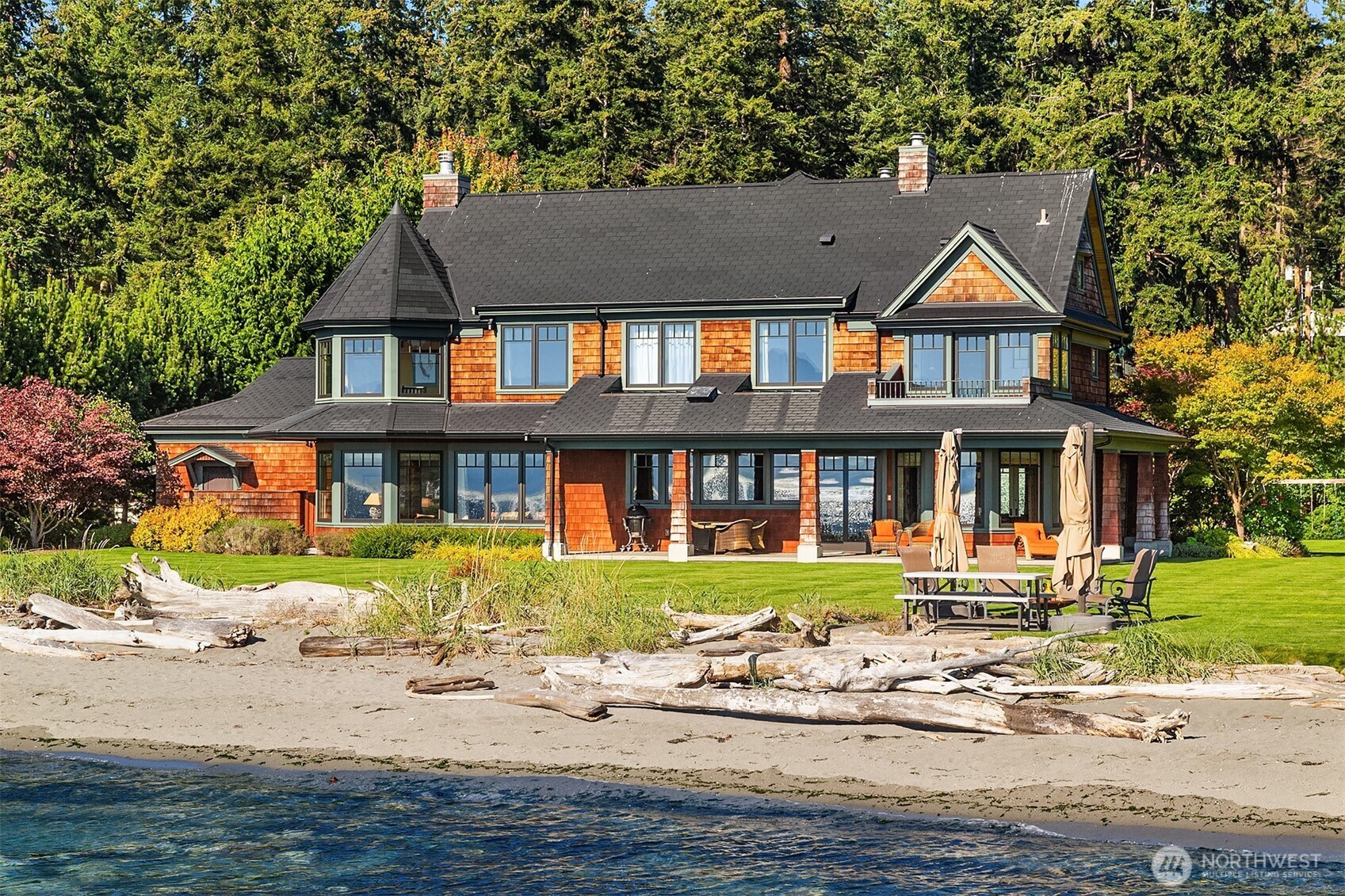 Where timeless elegance meets the sea, with 133 ft of private, no-bank, soft sandy beachfront on iconic Mutiny Bay, framed by sweeping views of Puget Sound and the Olympic Mountains. A refined estate with tasteful curated interiors, and a detached carriage house with additional entertaining space on one plus acre of pristine, gated grounds. Two beautiful structures, 7,000 sqft of exceptional living space, 2,500 sqft of garage and storage. Fully furnished and sold turnkey- an extraordinary offering, on the Islands most coveted shoreline.