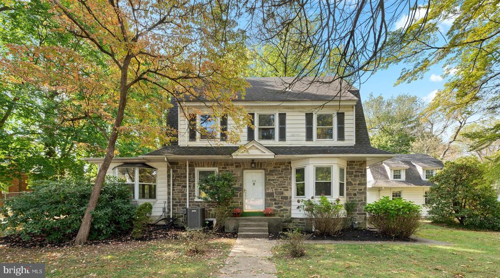 Welcome to 412 N. Rolling Road in popular Springfield! Spacious and gracious describes this lovely stone colonial, built in 1920 that sits on a very generous .72 acre lot with mature trees and shrubs. This home features  3,379 square feet that invites comfortable living and refined entertaining. Upon entry, be greeted by a spacious living room adorned with parquet hardwood flooring and a gas stone fireplace, leading seamlessly to a cozy family room through elegant French doors. Here, the double sided fireplace and walls of windows create a warm, inviting atmosphere. The adjoining sunroom, with its expansive glass roof, offers a serene retreat to enjoy the changing seasons. The kitchen is equipped with modern conveniences, like a stainless steel JennAir commercial grade 48" gas range and a delightful breakfast nook. Additional features include a powder room, a full laundry room, and a two-car garage with bonus room above (it was uses as a playroom for years) and a side storage shed. The formal dining room, with its triple windows and crown molding, sets the stage for memorable gatherings. The second level includes 3 nice-sized bedrooms with hardwood floors and a hall bathroom with a tub/shower combo. The third floor features 2 additional bedrooms, a cedar closet and a hall bathroom. Central air conditioning throughout!This charming home has so much space and a much larger lot then most homes in Springfield (almost 3/4 of an acre.) The yard is fully fenced (which is no longer allowed--perfect for a dog) Central air conditioning! Conveniently located near shopping, schools, community pool, and local parks.