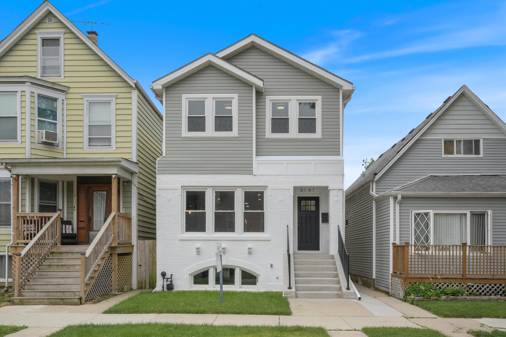 Located on the sought-after east side of Portage Park, this beautifully designed 4-bedroom, 3.5-bath single-family home sits on an extra-wide lot and offers generous space, abundant natural light, and elevated finishes throughout.  The open-concept main level features wide-plank engineered hickory flooring, northern and southern exposures, custom wainscoting, and a spacious living and family room anchored by a cozy fireplace. The chef's kitchen is outfitted with white shaker cabinetry, quartz countertops with warm veining, premium LG stainless steel appliances, and opens to a large back deck-perfect for indoor-outdoor living. A dining area and breakfast nook complete the space.  Upstairs, the primary suite includes a spa-inspired bath with herringbone tile, floating double vanity, walk-in shower with niche, and a massive walk-in closet. Two additional bedrooms, a second full bath, and a side-by-side laundry round out the upper level.  The finished lower level includes a fourth bedroom, full bath, and flexible space ideal for a home office, gym, or guest suite. Additional highlights include a new drain tile system with sump pump, tankless water heater, LED lighting throughout, and a 2.5-car garage.