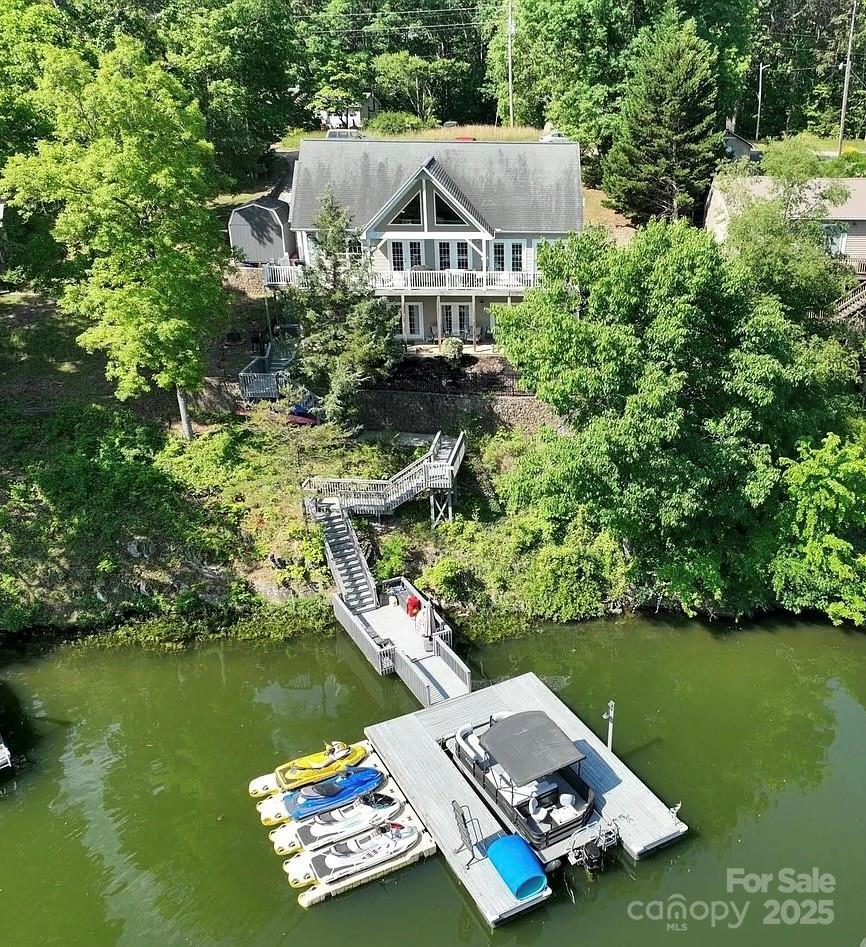 Custom built home offers serene setting for relaxing lake living!  Spacious 1 level home with finished basement that overlooks a wide deep cove on Badin Lake.  Open main level living that overlooks the beautiful lake with primary bedroom with master bath.  Open family area to kitchen with breakfast area and bar that also has a breathtaking view of the lake.  Dining room or Office on main level... you choose!  Basement offers 2 bedrooms with Jack and Jill bath, theatre room/bonus room, large bonus room with a view of lake, plus another full bath.  Paint and flooring was updated 3 years ago.  Boat Slip with 4 jet ski docks and ladder, level 2 charging available for electric vehicles.  Whole house fiber internet available.  This home has it all!