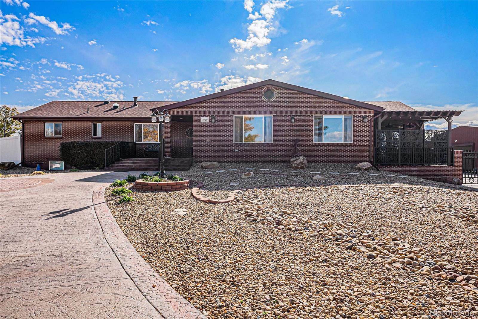 Experience the rare combination of luxury, land, and lifestyle at 7820 W. 96th Avenue — a meticulously maintained ranch-style estate on just over an acre in unincorporated Jefferson County. Enjoy country-style living with no HOA, space for horses or chickens, and the freedom to run a business or host a car collection — all minutes from city conveniences.

Car lovers will be in heaven in the 72’x58’ insulated shop, featuring six garage doors, 15-ft ceilings, 200-amp service, office, bathroom, heated epoxy floors, and full bar area — built to code with spray foam insulation, crane, and storage for up to 10 cars plus a 40-ft RV.

The open-concept main level features spanning islands, original hardwood floors, abundant natural light, and brand-new kitchen appliances (2025). The primary suite is a true retreat with vaulted ceilings, a massive custom walk-in closet with island, private deck, and in-suite laundry. The walk-out basement offers a full second living space with separate entrance, kitchen, laundry, and 3 bedrooms/2 baths — perfect for guests, multi-generational living, or a rental opportunity.

Outdoors, you’ll find three covered patios, a custom go-kart track surrounding a central pavilion for grilling & watching the game, a 3-hole putting green, and beautiful xeriscaped landscaping with astroturf and a zoned sprinkler system. $300K in concrete work, luxury motorized electric iron gates, the list goes on and on. Please allow a full hour for your showing in order to take in all of the buildings and property.

See virtual tour for additional pictures.