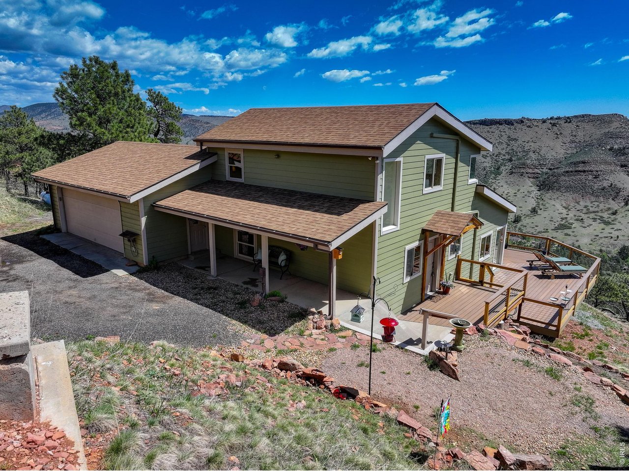 Residential-Detached built in 1983 on 2.96 acre lot in subdivision Lyons Park Estates. This move-in-ready, one-of-a-kind, hidden gem of a home offers spectacular views overlooking Heil Valley Ranch Open Space, while still being only 1.5 miles to downtown Lyons. Whether relaxing in front of the fireplace as the sun rises over the foothills through the adjacent window, or enjoying an eagle's eye view from the spacious, Trex deck, this home offers so much more than a roof over your head. Hardy siding and Marvin windows provide quality living. Enter the home and be greeted with vaulted ceilings and abundant, natural light. The main level has oak floors, including the entry, kitchen, living and dining room and bedroom. The countertop bar between the dining room and kitchen is topped with juniper wood, inlaid with turquoise accents, made by a local artist. The kitchen is equipped with a new dishwasher, as well as a newer gas range/oven. The laundry room has built-in shelves and a newer washer and dryer. The stairs and the bedrooms have newer carpet. The primary bedroom contains an ELFA closet system, keeping belongings well-organized. Both the upper and main level Mitsubishi Electric Mini Splits keep it warm in winter and cool in summer. Mountain scenery flows through the windows in the primary bedroom as well. The upstairs bathroom reflects a woodland design, blending seamlessly with the outdoors. Two bedrooms are non-conforming. Perfect for those seeking privacy, as well as access to Boulder, Longmont, Estes Park, Rocky Mountain National Park and DIA. Enjoy visits from deer and wild turkeys as you live like you're on vacation. Includes a one-year home warranty for peace of mind.