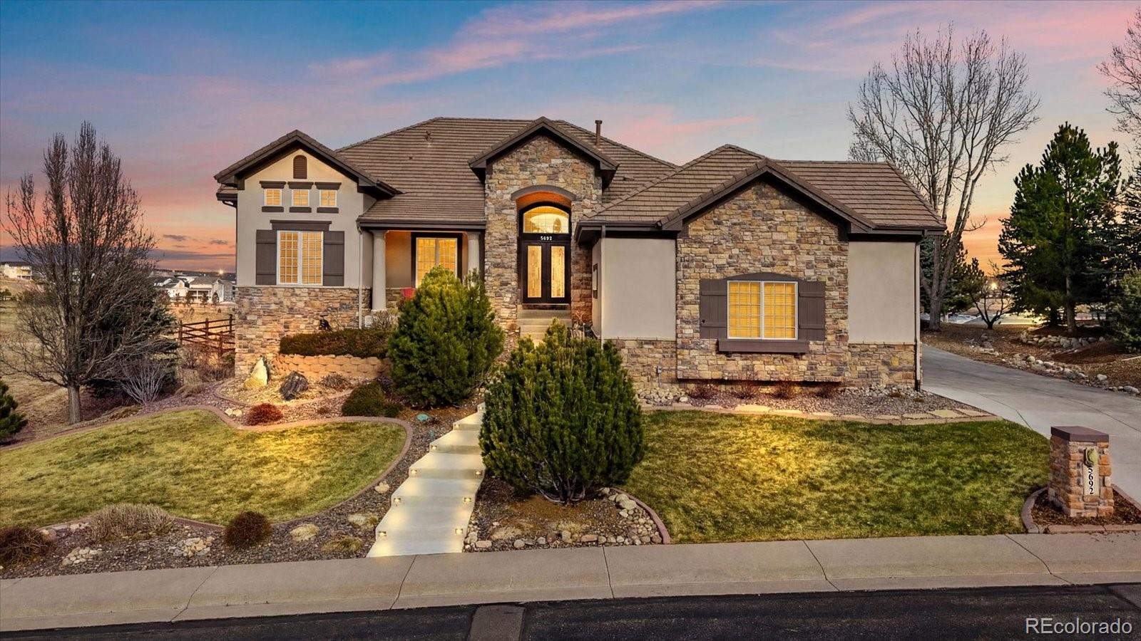 Set in the gated Vistancia enclave of Pradera, this 7-bedroom, 6-bath walkout ranch sits on one of the most private lots in the neighborhood, backing and siding to open space. The home offers nearly 7,000 square feet of comfortable, well-designed living with easy access to golf, trails, schools, the community pool, and downtown Parker.The main level makes a strong first impression with a 16-foot vaulted ceiling, warm hardwood floors, and big windows that frame the open space views. The primary suite is a quiet retreat with a 5-piece bath, large walk-in closet, and direct access to the deck. The kitchen has plenty of storage, a large island, walk in pantry, and opens to a casual dining area, and parlor room anchored with one of 4 fireplaces. Three additional main-level bedrooms or flex spaces sit just off the kitchen wing.  Completing the main level are a guest half-bath and laundry/mudroom with access to the side-loaded 4-car garage with 15-foot tall ceilings, perfect for the car and gear enthusiast. The walkout lower level is ideal for multigenerational living or an au pair, offering three more bedroom suites, a second kitchen, a large family room, a game room, and generous storage. A second set of laundry appliances adds additional convenience. Outdoor living is a highlight with a half-acre lot, covered patio, new Trex deck, fenced yard, garden beds, and wide open views in every direction. Don’t miss this rare combination of space, privacy, and thoughtful design in Pradera’s most sought-after gated communities.