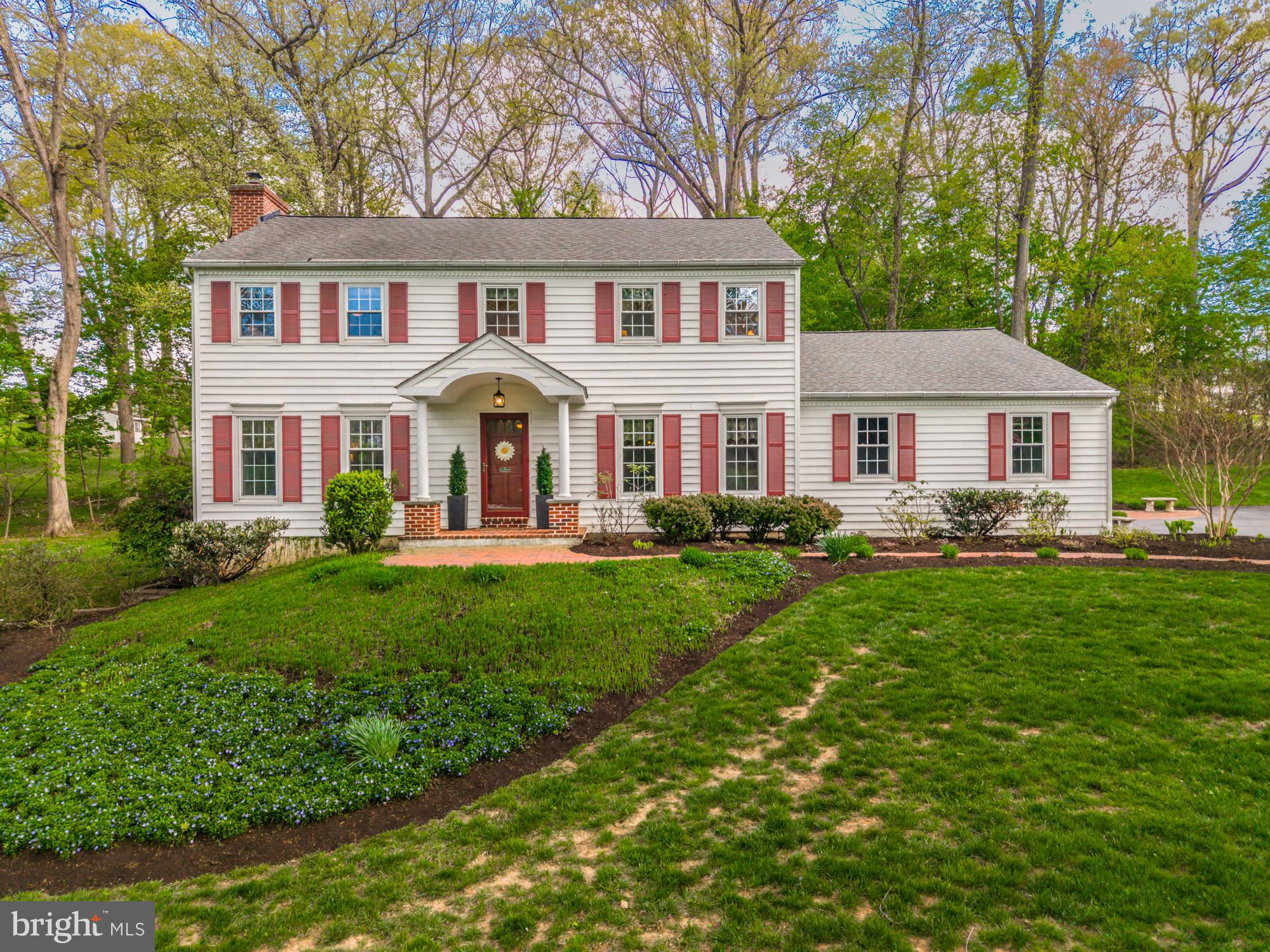 Tucked just off a quiet cul-de-sac, this inviting home is filled with character and gracefully set on a spectacular one-acre lot, professionally landscaped and teeming with beautiful perennial flowers and mature trees. A brick walkway and charming front door portico create an elegant entrance to the home’s grand foyer with hardwood floors. Flanking the foyer are spacious formal dining and living rooms, also with hardwood, offering exceptional space for everyday living and entertaining. The dining room features deep-set windows and a chair rail, while the living room is anchored by a brick fireplace and showcases sweeping views of the pretty and private backyard. A powder room is perfectly positioned at the end of the hall. This home’s updated kitchen with stainless steel appliances opens to the most delightful breakfast alcove with two deep-silled bow windows, offering a sunny spot for morning coffee and more lovely views of the yard. The adjacent family room, with a beamed cathedral ceiling and skylights, is a cozy gathering space featuring a floor-to-ceiling brick, wood-burning fireplace and sliding doors that lead to a striking hardscaped brick patio nestled among the flower beds. A laundry room with closets, cabinets and a utility sink plus direct backyard access is also conveniently located on this main level. Upstairs, the primary suite offers a peaceful retreat, complete with a third fireplace, a spacious walk-in closet, and an updated en-suite bath adorned in travertine, featuring a walk-in shower and double vanity. A wide hallway leads to three additional well-sized bedrooms and a second updated full bathroom. This home also has a finished walkout basement that includes an exercise room and a home office, as well as a pristine, oversized two-car garage with epoxy flooring. Ideally set near township preserved open space, and just minutes from major routes, shopping, dining, and all the fun that West Chester and Malvern Boros have to offer, this home brings the best of convenience in a serene setting. Make your appointment today!