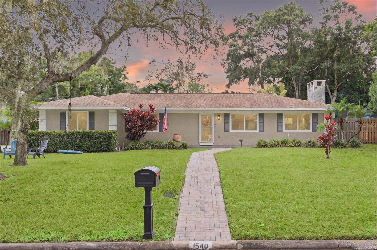 One or more photo(s) has been virtually staged. Come see this amazing home on 2 lots in the desirable Clearwater neighborhood of Glenwood! With more than 1/4 acre of land in a Non-Evacuation zone, no flood insurance required and no HOA. This 3 bed 2 bath, 2 car garage home is ready for you to move right in. Upon walking in you will feel right at home with the open floor plan which includes plenty of spaces to create a cozy nook or office around the wood burning fireplace. The bedrooms are nicely sized and primary bedroom includes an ensuite bath.  The large family room in the rear offers many opportunities as a perfect flex space for play room, family space, man cave or more!  Recent updates include NEW Impact Rated Windows, NEW updated electrical and panel, A/C in the garage, an 8x8 office outfitted in the garage, NEW whole home water filtration system and under sink RO by Purity Bay, irrigation on well, new sod, new fencing, new pavered patio and more! Roof is about 10 years and A/C is about 6 years.  Don't miss out on this amazing opportunity!