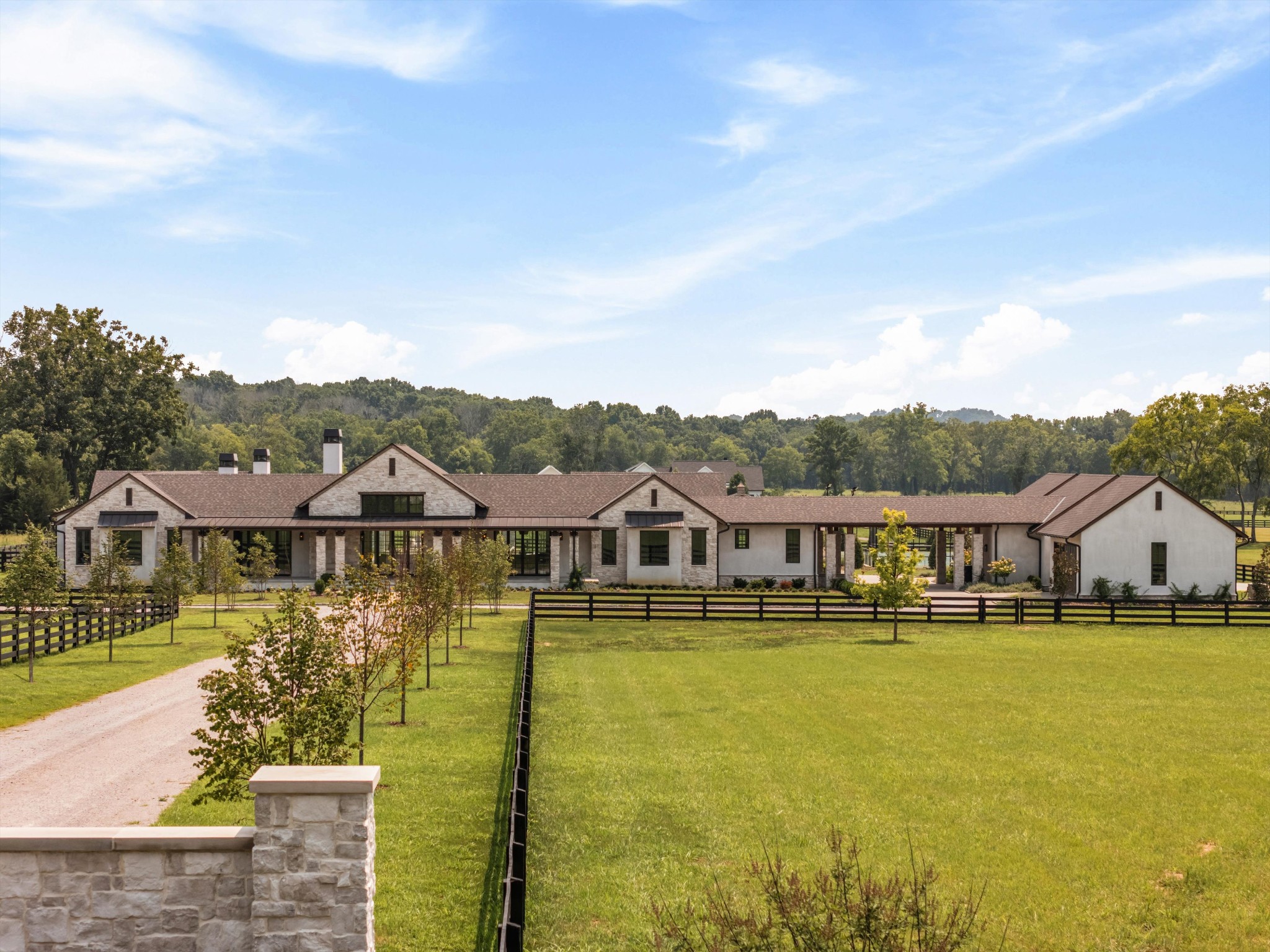You will not find another house like this in Tennessee. Texas ranch meets European design. You have to see this home in real life to understand the level of quality and craftsmanship that has gone into this marvelous 2025 build. This home was planned and executed as a forever home, and this is your opportunity to savor the final product of 5 years of planning and execution.  Extraordinary gated European-inspired estate on 7.55 level private acres offering exceptional one-level living with retreat-style amenities. Authentic cement stucco and stone exterior, timeless arched architecture, soaring wood beams, and designer finishes throughout. Spectacular designer kitchen with custom White Oak cabinetry, marble countertops, Wolf appliances, separate refrigerator/freezer, breakfast nook, built-in china cabinetry, and fully equipped scullery kitchen with additional refrigeration, ovens, prep sink, and abundant storage. Luxurious primary retreat with fireplace, dual custom walk-in closets, European sauna, soaking tub, oversized shower, and private gallery entrance. Three additional oversized ensuite bedrooms plus private guest/in-law suite with built-ins, refrigerator, large closet, and direct pool access. Designed for entertaining and everyday luxury with formal dining, private office, gym, bonus room, theater, game room with golf simulator and bar, pet suite, and dual drop zones. Outdoor living is exceptional with resort-style pool/spa, electric pool cover, screened porch, covered outdoor kitchen, expansive heated entertaining porches, and stunning cedar ceilings/beams. Sports enthusiasts will love the tennis/pickleball/basketball court and 36x56, 4-stall barn complete with tack/feed room and a space for future wash stall or additional stall. Additional features include European White Oak floors, custom site-built closets, Marvin doors, Sierra Pacific windows, encapsulated crawl space, foam insulation, oversized 6 car 2,311 sq ft garage.  State of the art video/security