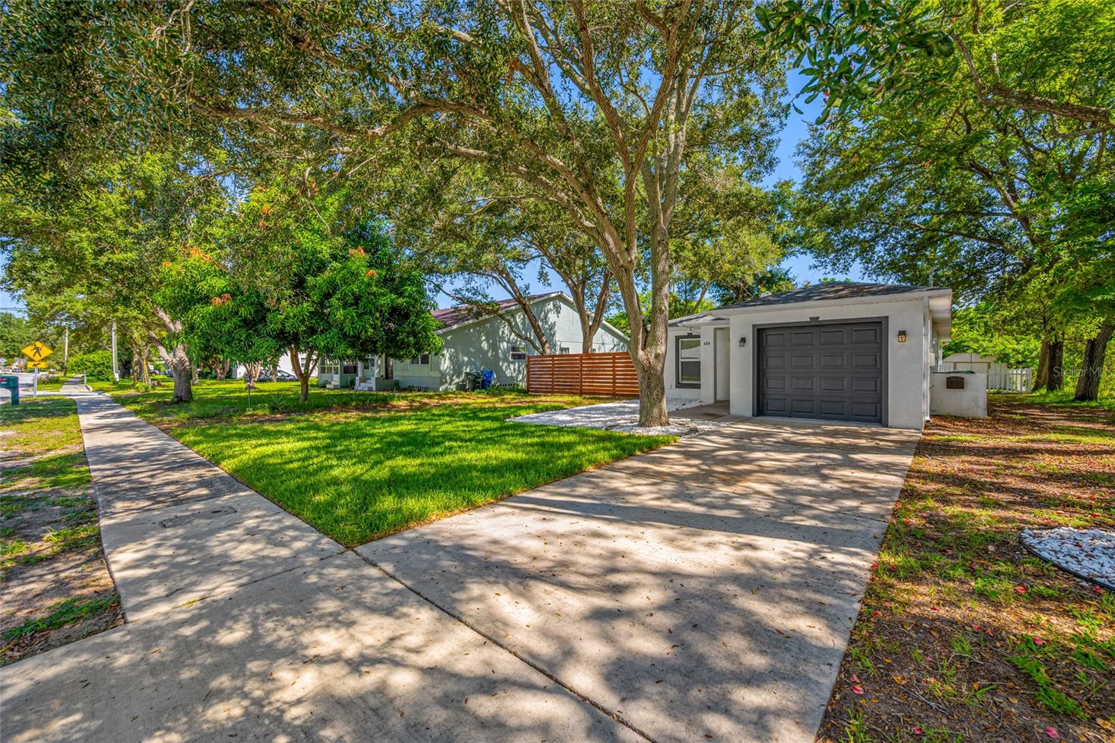 Modern style, fresh finishes, and a brand-new roof! This newer-construction, three-bedroom, two-bath home with a one-car garage blends contemporary flair with thoughtful upgrades throughout. Professionally refreshed, it features updated fixtures and an abundance of added lighting that highlights its modern character and creates a bright, inviting atmosphere.Step into a kitchen that's ready for your next meal. The stainless Samsung range, KitchenAid dishwasher, and spacious LG French-door refrigerator are all included, so you can move in and start cooking. A NuTone range hood keeps things fresh. Open the kitchen sliders and step out onto an 11x16 wood deck, perfect for morning coffee, grilling, or soaking up the Florida sunshine.Out back, a 10x13 metal shed stays with the home and provides plenty of storage for tools, lawn equipment, and weekend gear. Stay comfortable year-round with a Lennox heat pump system and backup electric heat for those cooler Florida mornings. The garage comes with a Chamberlain opener and an A.O. Smith water heater, so the essentials are already in place.Every space feels fresh and ready to welcome its next owner. With its distinctive style and beautifully updated presentation, this home is a standout opportunity to enjoy modern living from day one.