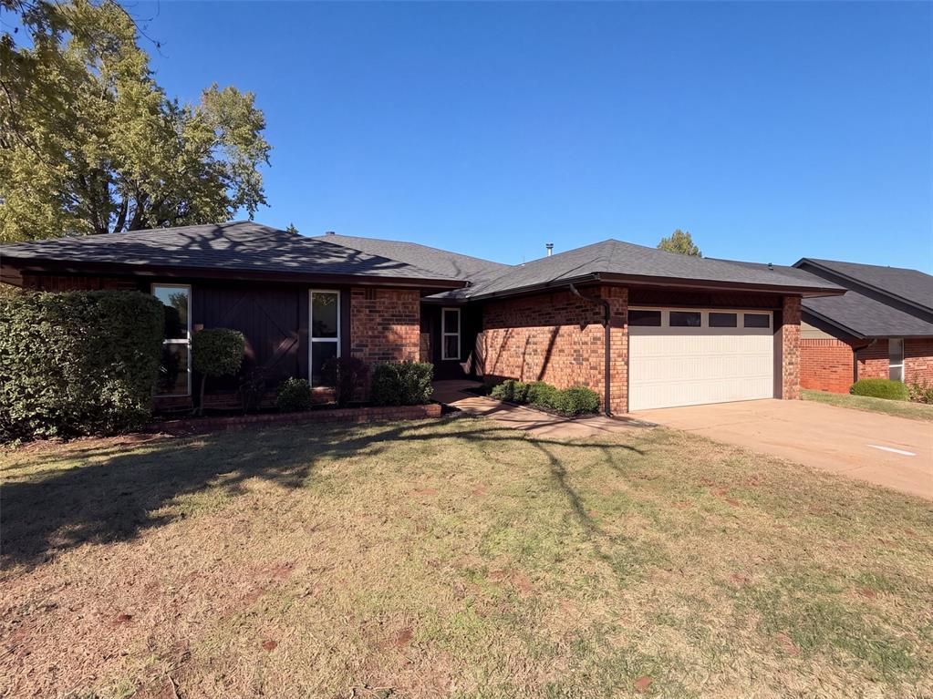 2717 Rolling Hills Ter is a single-story Edmond home with a vaulted living room, a prominent fireplace and an exposed ceiling beam. A broad kitchen pass-through keeps the cooking and living areas connected, while ample cabinetry and counter space support everyday preparation. The primary bedroom has an adjoining double-sink vanity area and a walk-in closet, with secondary bedrooms set along the hall. A dedicated laundry room includes extensive built-in shelving for additional storage. Outside, the covered patio opens to a fully fenced backyard with mature trees. An attached two-car garage rounds out a layout that balances connected gathering spaces with distinct bedroom areas. Included 100-Day Home Warranty with buyer activation