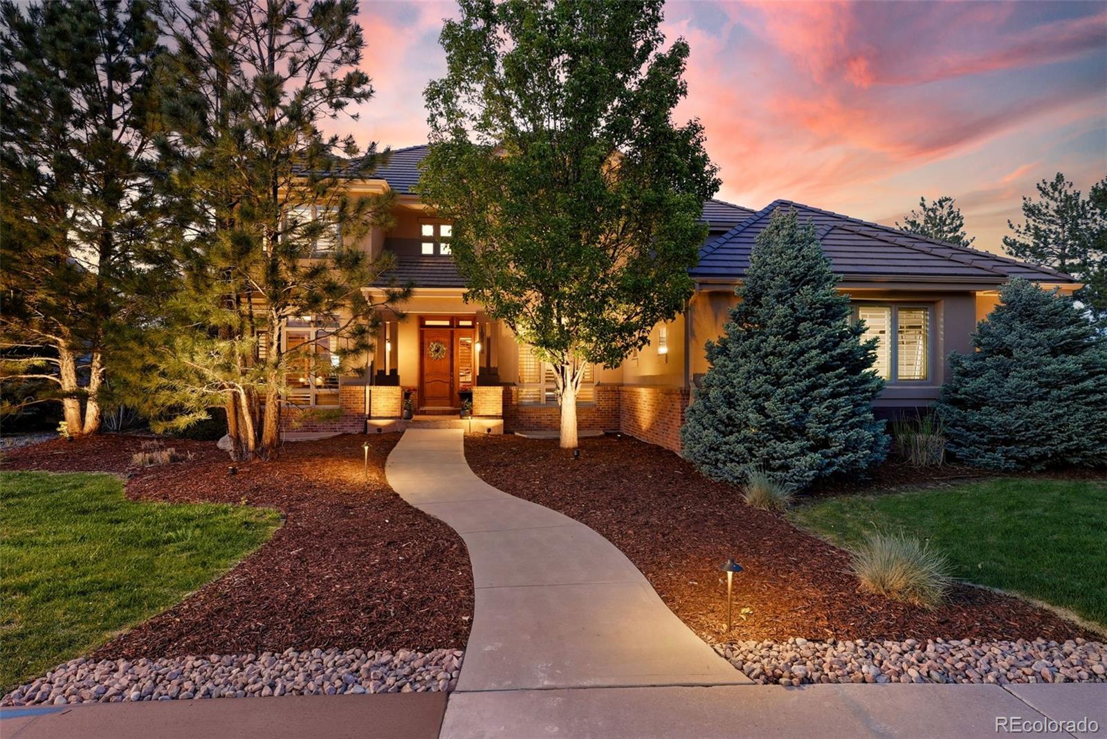 Tucked within the gated Highwoods community of Highlands Ranch, this extraordinary estate seamlessly blends timeless elegance with elevated modern living. Rich Australian Cypress hardwood floors, exquisite crown moulding, and refined architectural details create a warm yet sophisticated atmosphere throughout the home. Designed with both grand entertaining and everyday comfort in mind, the residence features four interior fireplaces along with a stunning outdoor fireplace, creating inviting spaces to gather year-round. The beautifully landscaped backyard is a private resort-style retreat, complete with a stunning pool and slide, luxurious hot tub, and multiple outdoor living spaces designed for unforgettable evenings under the Colorado sky. Inside, the expansive media room delivers a true cinematic experience with a newer projector installed in 2024, while the home’s impressive wine cellar, equipped with a WhisperKOOL chilling system, offers the perfect showcase for a prized collection. At the heart of the home, the thoughtfully updated kitchen combines luxury and functionality with a new stove, oven, and microwave installed in April 2026, along with a newer dishwasher added in 2025. Additional recent improvements include a replaced main-floor A/C unit in 2025, ensuring year-round comfort and efficiency. Generous storage, sophisticated finishes, and carefully curated upgrades throughout make this residence as practical as it is beautiful. This is a rare opportunity to own an exceptional luxury home in a premier gated community where privacy, elegance, and resort-style living come together effortlessly. Every detail of this home has been meticulously maintained to provide a turnkey experience for the most discerning buyer. From the tranquil outdoor spaces to the high-end technical upgrades, this estate offers a lifestyle of unparalleled quality and grace.