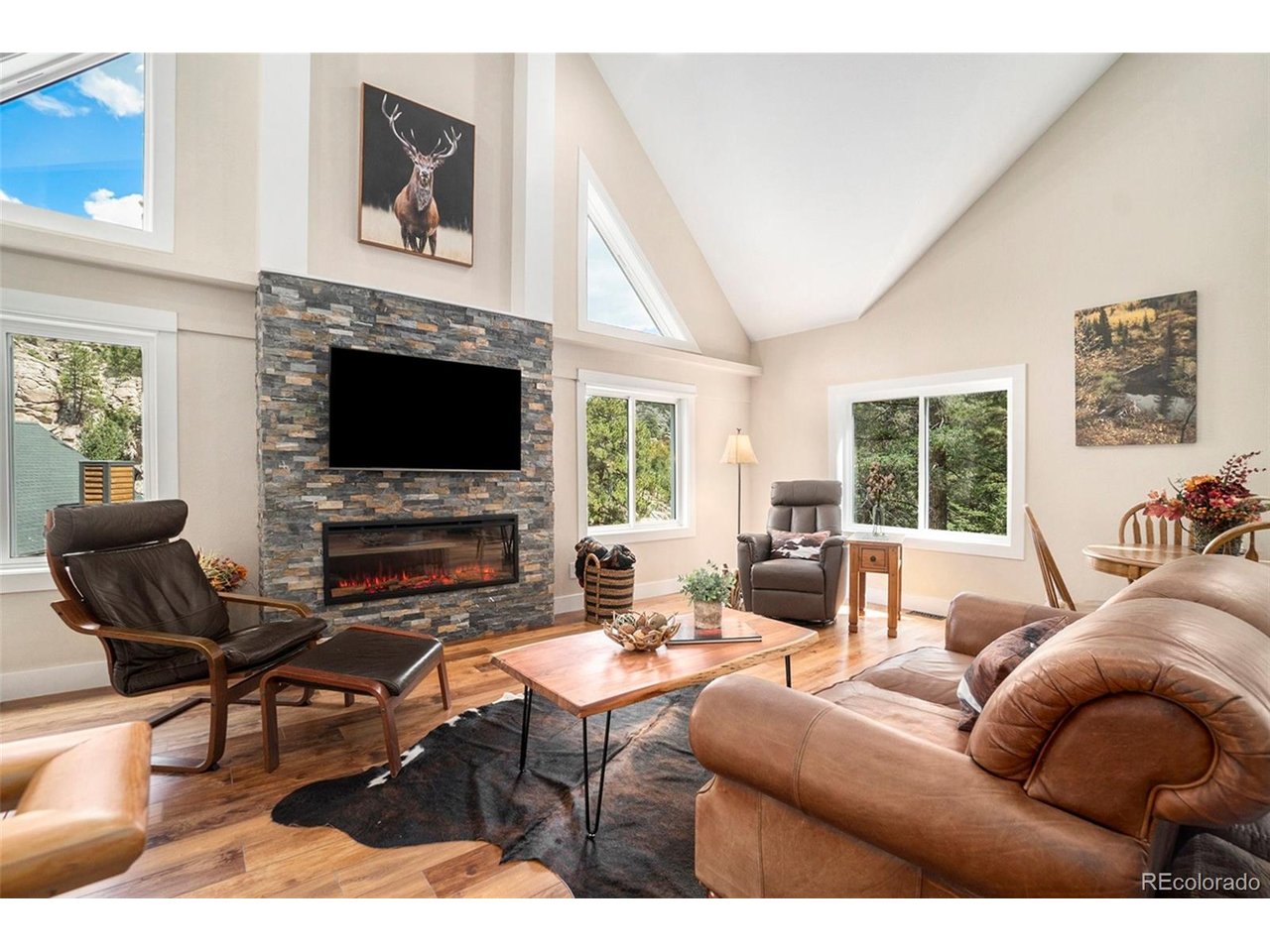 Escape to your own private mountain retreat just 3.8 miles from downtown Estes Park. Nestled on 4.9 acres bordering National Forest and the Big Thompson River, this beautifully renovated property is a dream for outdoor enthusiasts seeking adventure, exploration, and relaxation. The main home has been completely updated and features vaulted ceilings, wood-burning stove, and an easy-to-use electric fireplace that creates year-round ambiance. The sun-filled kitchen boasts new cabinetry, quartz countertops, a large center island, spacious pantry, and beverage center with cooler, while overlooking whispering pine trees and the shimmer of the river below. Outside enjoy the great outdoors or relax on the deck where you can enjoy morning coffee, summer BBQ's or an evening around the fire under the stars. Inside, retreat to the spacious primary suite offering vaulted ceilings, skylights, a private ensuite bathroom with walk-in shower, convenient laundry closet, and a versatile loft area ideal for a home office or flex space. Recent improvements include energy-efficient double-pane windows, durable luxury vinyl flooring, new carpet in the upper-level bedrooms, updated bathroom vanity and lighting, a new roof, and fresh interior and exterior paint. Adding to the property's charm is a separate 340 square-foot rustic cabin. This bonus structure provides flexible space for a guest retreat, studio, hobby room, home office, or peaceful getaway. Whether you're enjoying the fresh mountain air, hiking directly into National Forest, casting a line in the river, spotting local wildlife, or simply relaxing, this exceptional property offers the perfect blend of modern comfort and Colorado mountain living. Create lasting memories with family and friends in a setting where adventure begins right outside your door.