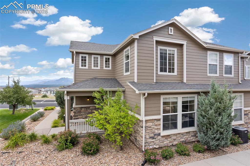 Situated on a stunning lot that not only offers Pikes Peak, Front Range, and Air Force Academy Views, this darling townhouse also is well located with ample guest parking and picnic tables, perfect for entertaining and watching the Thunderbirds!  The 7 x 7 covered front porch leads directly into the entryway featuring daylight windows and luxury vinyl flooring for durability.  The great room not only offers lots of natural lighting, but also has beautiful views of the landscaped retaining wall that also offers privacy from rear neighbors.  The adjoining dining area features adequate wall space for furniture and a breakfast bar that is open to the kitchen.  The smartly designed kitchen has upgraded maple cabinets with crown molding, a built-in microwave, electric range oven, Formica counters, is located off the fully finished garage with built-in shelving.  Also located on the main level is a spacious storage closet with access to the crawl space, the laundry area with electric hook up and built-in movable shelving, and a half bath featuring a 36” wide door for easy assessibility, a pedestal sink, and a window overlooking side yard.  The upper level offers two spacious secondary bedrooms, and a full bathroom featuring double sinks, a medicine cabinet, and a separate area with the tub/shower and commode.  The primary suite has gorgeous Pikes Peak and Front Range Views, a vaulted ceiling, a 6 x 8 walk-in closet, and an adjoining full bath with double sinks, a medicine cabinet, a linen closet, maple lower cabinets, and a tub/shower combo that also offers those gorgeous views of the mountains and Air Force Academy.  This low maintenance home has A/C, is move-in ready, and is within a short distance to shopping, dining, schools, and access to I-25.