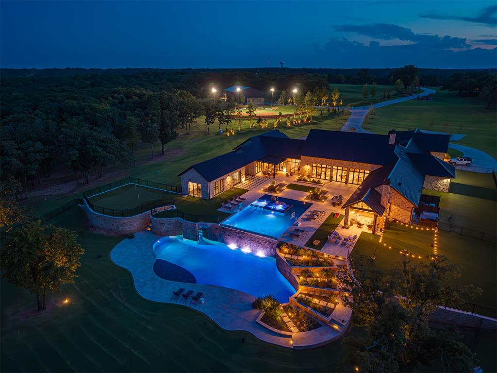 There are luxury homes… and then there are estates that truly take your breath away. This is unquestionably one of the most extraordinary and luxurious properties in all of Oklahoma. Impeccable design, exceptional craftsmanship, and a commitment to excellence are evident in every detail of this remarkable one-level estate, located just 40 minutes from Edmond.Designed with no expense spared, the home showcases elevated finishes throughout, including designer elements such as Gucci wallpaper and refined architectural detailing that set it apart from anything else on the market. Two dedicated office/study areas provide flexibility for work, business, or creative space, all thoughtfully integrated into the home’s seamless single-level layout.The primary suite is a true retreat—beautifully designed with a spa-like feel and featuring his & hers closets that deliver both luxury and functionality at the highest level.The outdoor amenities rival a private resort. A stunning $2M two-level pool serves as the focal point of the backyard, complemented by a luxury hot tub, expansive outdoor living areas, and a fully equipped outdoor kitchen designed for entertaining on any scale. The private putting green, tranquil pond, and professionally lit baseball field create a truly one-of-a-kind setting—perfect for evening games under the lights.Additional features include a private gated entry, guest house, workshop, RV hookups, indoor pickleball and basketball courts, and a state-of-the-art $150,000 Crestron smart home system providing effortless control throughout the property.This is more than a home—it is a private compound built for lifestyle, performance, and legacy. A rare opportunity to own one of Oklahoma’s most luxurious and amenity-rich estates. Around $3M in custom furniture is included.