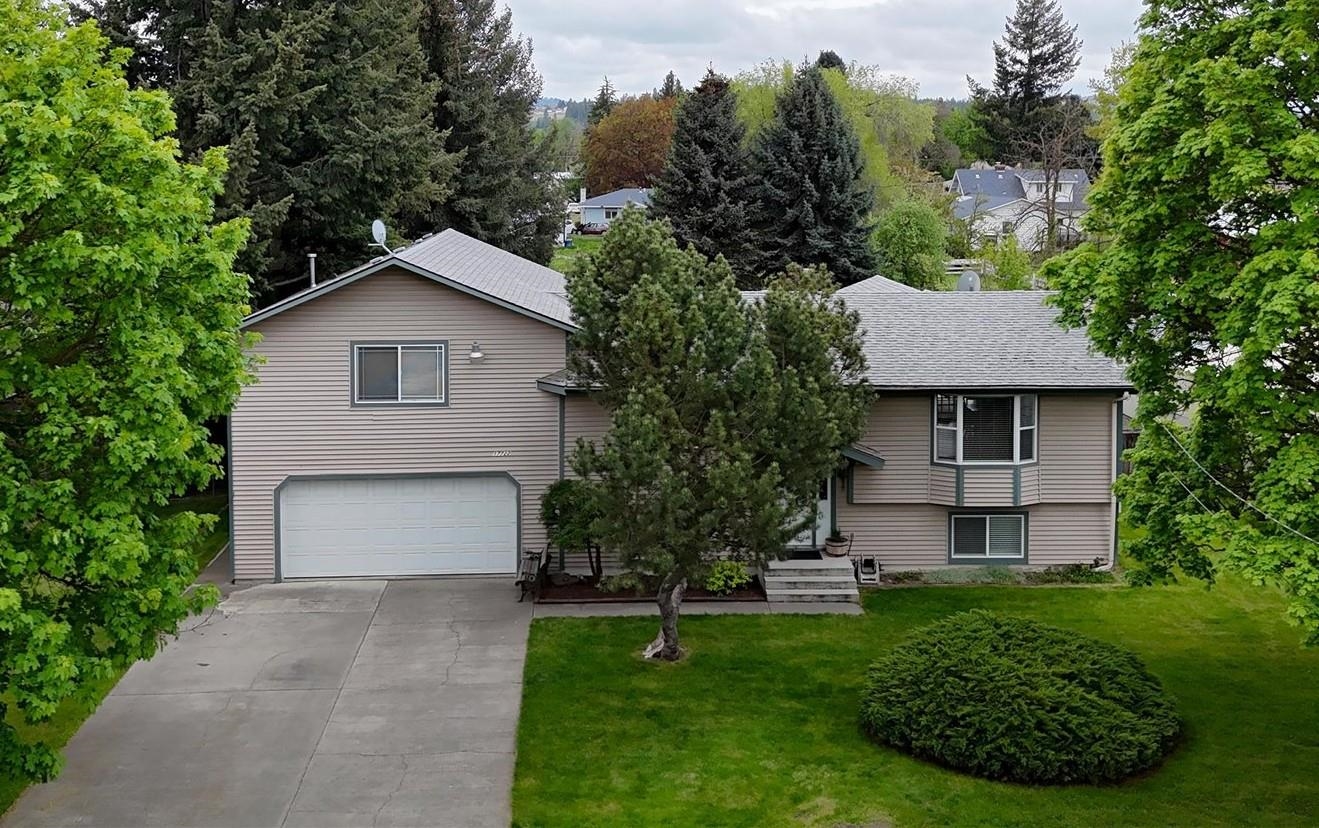 This Meticulous South Valley home sits on an oversized lot on the quiet end of Broadway with 2 car garage, RV Parking and a detached garage/shop plus room for your animals. Hardwood flooring throughout main floor. The 5 bedrooms include a giant primary suite with 3 closets, ensuite with walk in shower and double sinks and a slider leading out to a private covered deck. Great Room Concept with fireplace on main floor has updated kitchen with solid surface counters, pantry, plus newer appliances and slider that leads to a large covered deck overlooking the expansive backyard. Basement has brand new LVP flooring, a 2nd family room, laundry, 3rd bathroom, 2 additional bedrooms and a 6th room that could be bedroom/den/workout space. Garage also has a toilet and sink! This house is spotless.... move in ready! Don't miss it.