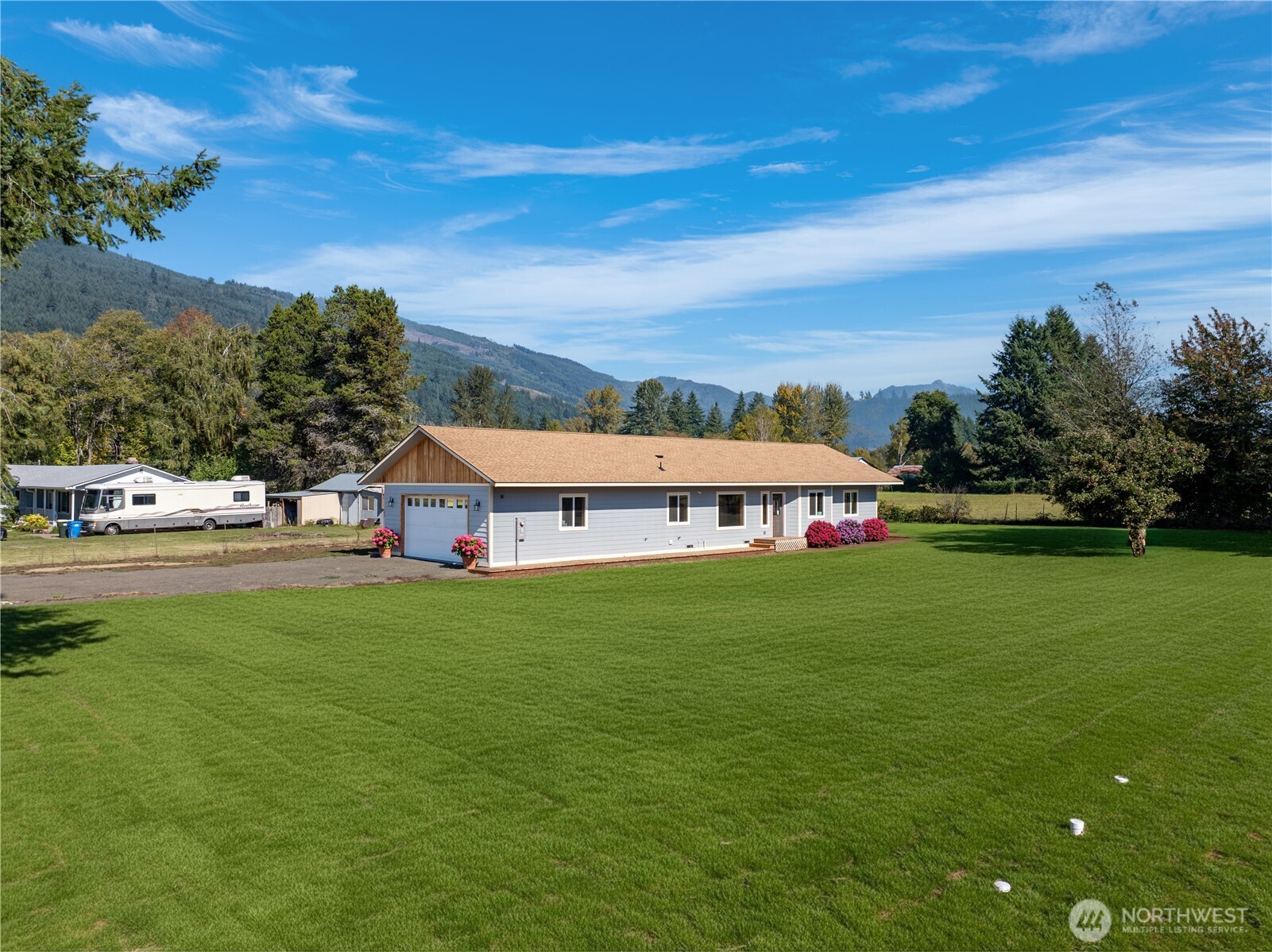 Brand New Home with Premium Upgrades & Mountain Views! Welcome to this stunning newly built three-bedroom home, thoughtfully designed with elegant upgrades and custom finishes throughout. Step into the inviting living room featuring a striking stone fireplace and warm tongue-and-groove pine paneling—perfect for cozy evenings and relaxed entertaining.The kitchen boasts custom solid wood cabinets with soft-close drawers, beautifully complemented by high-traffic, scratch-resistant plank flooring as well as SMART led lighting. Custom interior doors, and wood-wrapped windows add a touch of craftsmanship and sophistication to every room. Step out onto the deck and take in breathtaking views of the surrounding mountains—your own private escape.