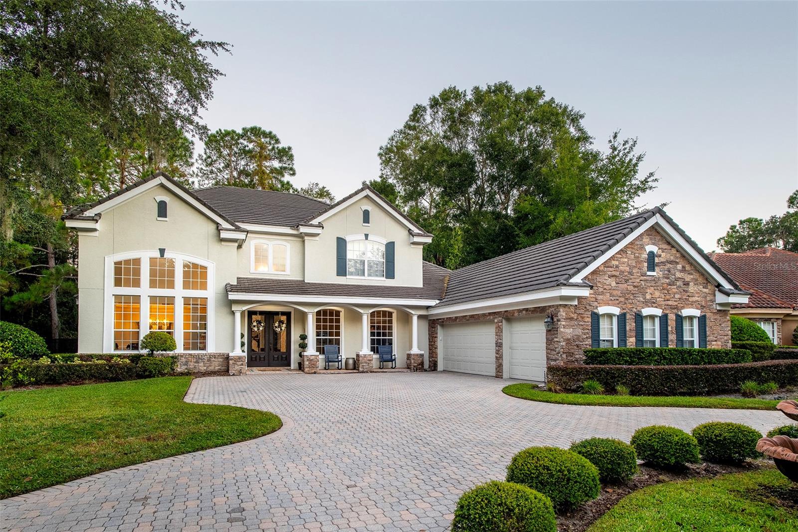 Fully remodeled executive home in the highly coveted community of Lake Forest with 4 bedrooms, 3.5 baths, office, bonus room, pool and 3 car side entry garage. Located on a quiet cul-de-sac lakefront lot. Travertine floors, soaring ceilings and a graceful curved staircase greet you upon entering. The kitchen was reconfigured for better functionality with all new cabinetry, a large center island with second full sink, GE Monogram six burner gas stove, built-in fridge, oven and microwave, walk-in pantry with wood shelves and quartzite counters. The family room renovations include a fireplace with floor to ceiling stone mantle, remote controlled blinds and alcoves with lower cabinets, wooden shelving and quartzite counters. Primary bedroom is downstairs and features a completely renovated bathroom with enormous shower (with multiple shower heads/jets), free standing tub, new vanities and storage cabinets, high end light fixtures and a private water closet with Toto commode. Connected to the bathroom is a very large walk-in closet with built-ins and center island for additional storage. A second door connects the closet to the fully remodeled laundry room.  The living room, dining room and office are also located on the first floor. The generous sized office with hardwood floors and French doors could be converted into a fifth bedroom. The second floor consists of three bedrooms, two bathrooms plus a bonus room, all with wood floors. Two of the bedrooms share a remodeled bathroom with separate vanities. Enjoy the expansive lanai year round- heated saltwater pool, paver patio, large covered area, fire pit, and lake view! One AC replaced 2021, other two replaced 2025. Lake Forest offers a 24-hr guard-gated entry with resort style amenities: 10,000 sq ft clubhouse w/ newly remodeled fitness center, Jr. Olympic-sized swimming pool, heated spa, kiddie pool, playground, 55-acre private spring-fed lake, fishing pier, new lighted tennis and pickleball courts & a sports court. The community has been designated as a National Wildlife Habitat. Lake Forest is zoned for Seminole County schools and is close to beaches, attractions and all that Central Florida has to offer! Easy access to I-4, 417 and 429.