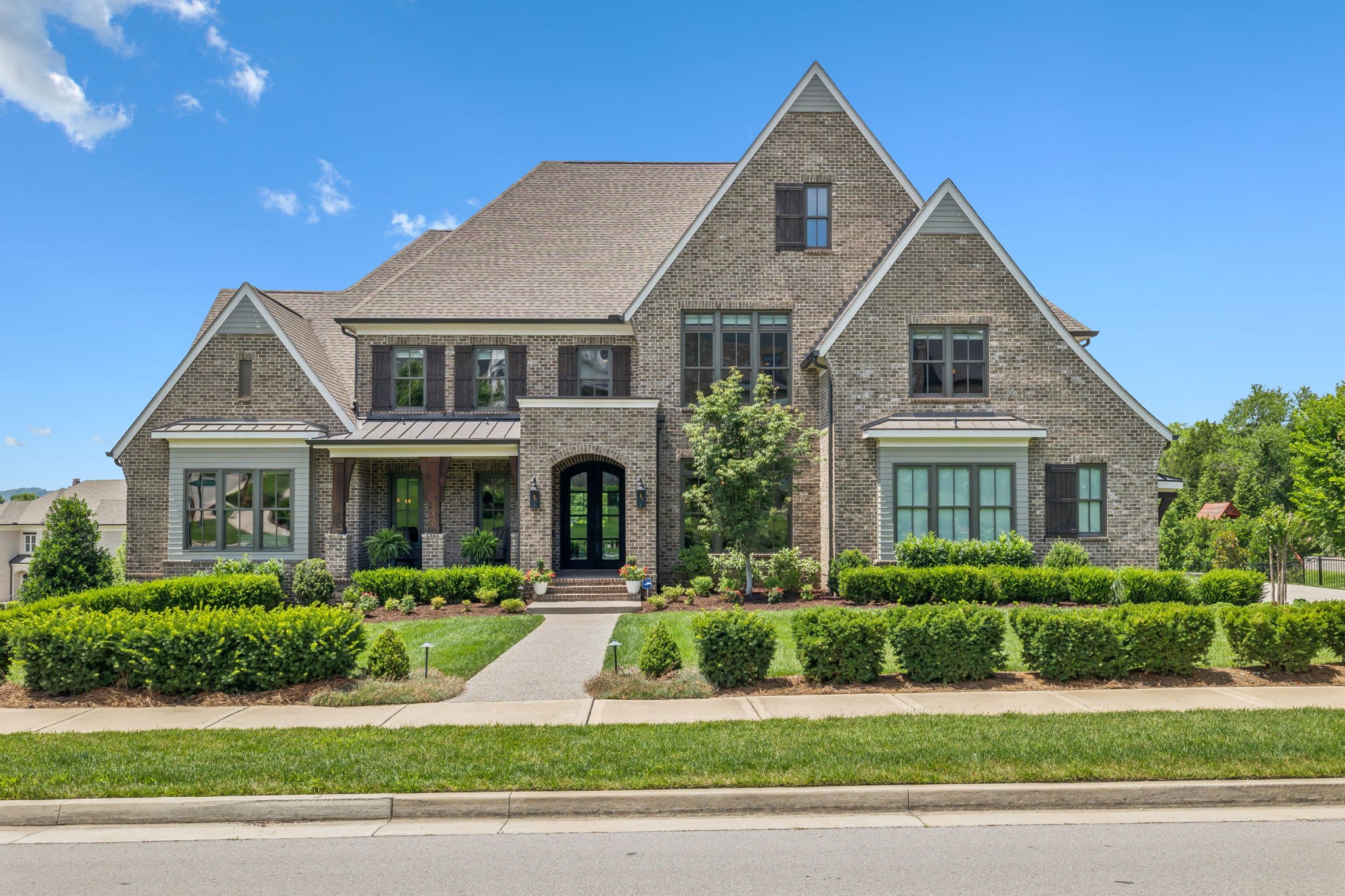 This stunning 6 Bedroom, 6 Full & 2 Half Bathroom home in one of Brentwood’s most sought-after neighborhoods was designed with entertaining in mind. From the four-car garage to the five outdoor living spaces, four fireplaces, and a outdoor kitchen, every inch of this home invites you to gather, celebrate, and enjoy. Inside, the home features a dramatic two-story entry, elegant formal dining room, study with custom bookcases, and a soaring great room with floating built-ins. The gourmet kitchen opens to a vaulted keeping room and is complemented by a butler’s pantry/caterer’s kitchen, perfect for hosting with ease. The main-level primary suite offers a private sitting room, his-and-hers bathrooms, custom closets, and its own washer/dryer. Each of the six bedrooms includes a private en suite and custom closets, with two additional guest half baths throughout. Upstairs, a media room, game room, and wet bar create the ultimate teen retreat, while the lower level includes a full second kitchen, wet bar, home gym, yoga/dance studio, and a space wired for a golf simulator. This area is ideal as a man cave, in-law suite, or multi-generational living space. Enjoy sunset views from the upper deck and screened porch, and take part in neighborhood events such as food trucks, movie nights, and socials at the nearby clubhouse and pool. You can also choose to relax in the comfort of your own private paradise at home.