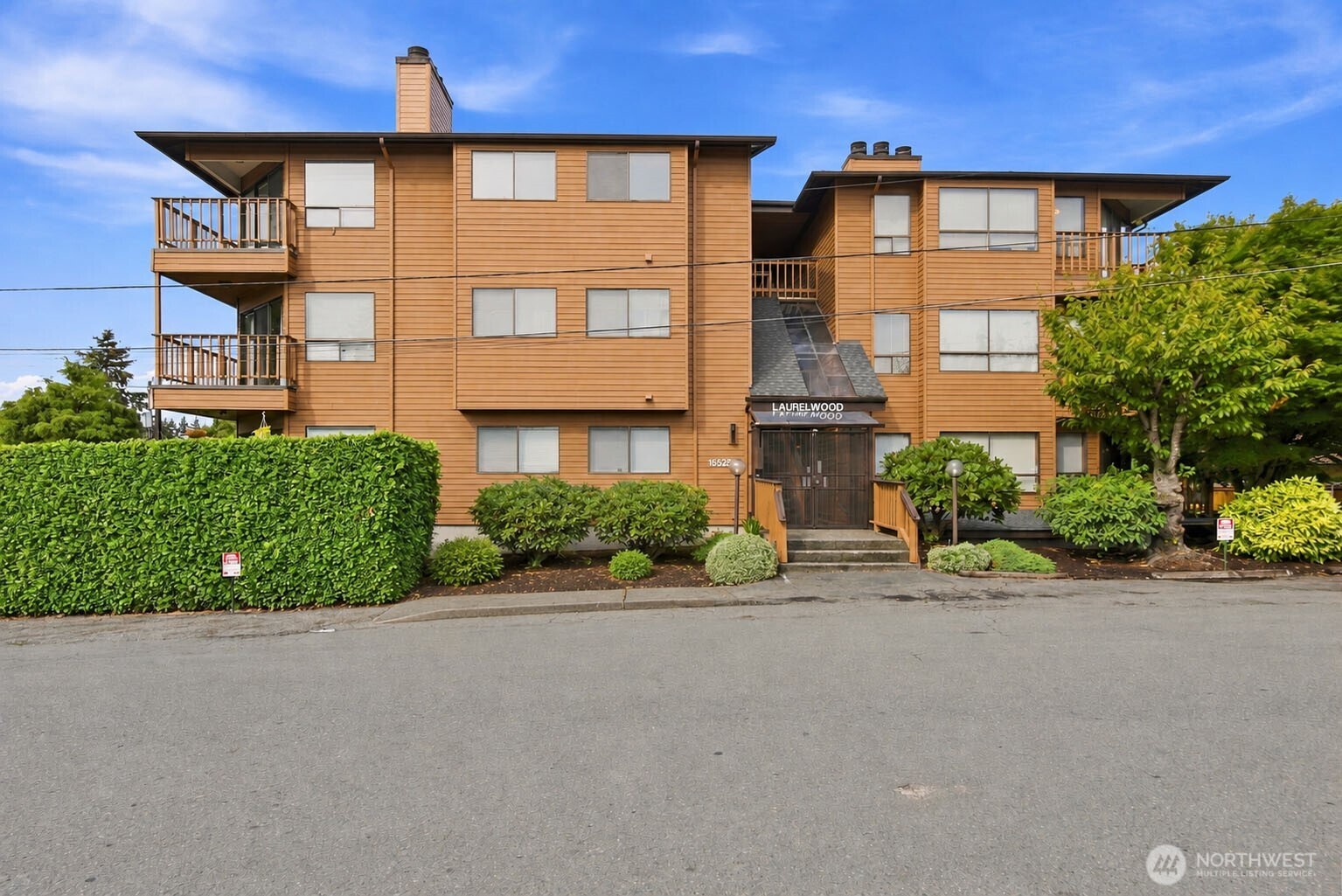 Discover easy, low-maintenance living in this beautifully refreshed top-floor corner condo, ideally located in the heart of Burien. This peaceful 2-bed/1.75-bath home offers a quiet, private setting filled with natural light & designed for both comfortable everyday living & effortless entertaining. The refreshed kitchen shines with new countertops, new flooring, & a seamless connection to the dining & living areas. Fresh interior paint creates a bright, move-in-ready backdrop, while the cozy wood-burning fireplace adds warmth & charm during the cooler months. Enjoy the welcoming front entry with room for a bistro table, chairs, or seasonal planters, plus a private back deck nestled among the treetops. Surrounded by greenery, this serene outdoor retreat feels tucked away from it all & is perfect for grilling, relaxing, or enjoying a quiet morning coffee. The spacious primary suite offers an en-suite bath & generous closet space, while the 2nd bedroom & guest bath provide flexibility for visitors, a home office, or additional living needs. Located in a quiet, well-maintained 14-unit community, this secure building offers elevator access from the gated garage, two assigned parking spaces, & a dedicated storage unit, providing stair-free accessibility to the home. Enjoy territorial views, along with a convenient location just minutes from local shops, restaurants, parks, & major transportation routes. HOA dues include water, sewer, & garbage.