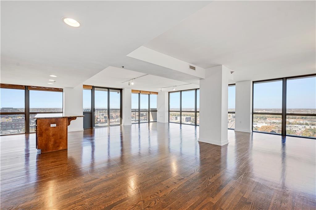 Wonderful opportunity to own a beautiful condo at The View, a name that truly says it all! Massive 1600+ square foot unit with loads of natural light and accented by floor-to-ceiling windows in every room. Two full balconies flank east and west sides of unit for the most amazing sunrises and sunsets. Open floor plan features hardwood and tile floors with carpet in bedrooms. Layout easily accommodates a large living room, formal dining and bonus office area. Spacious kitchen features granite counters, loads of cabinet space, stainless appliances & huge eat-in island.  Well appointed bathrooms with granite counters, tile floors, large shower + separate tub  + double vanity in primary. Both bedrooms feature views galore plus huge walk-in closets. Laundry conveniently located in hallway closest. Two additional storage rooms come with condo condo with ample storage space. Indoor parking space is included for two cars. The View is a modern high rise building located between Kansas City’s Rivermarket and Central Business District. Building amenities include pool, party room, movie theater, game room, 24 hour concierge, and fitness room. Easy street car access to Power & Light for entertainment, local dog parks, KC Current stadium and more!