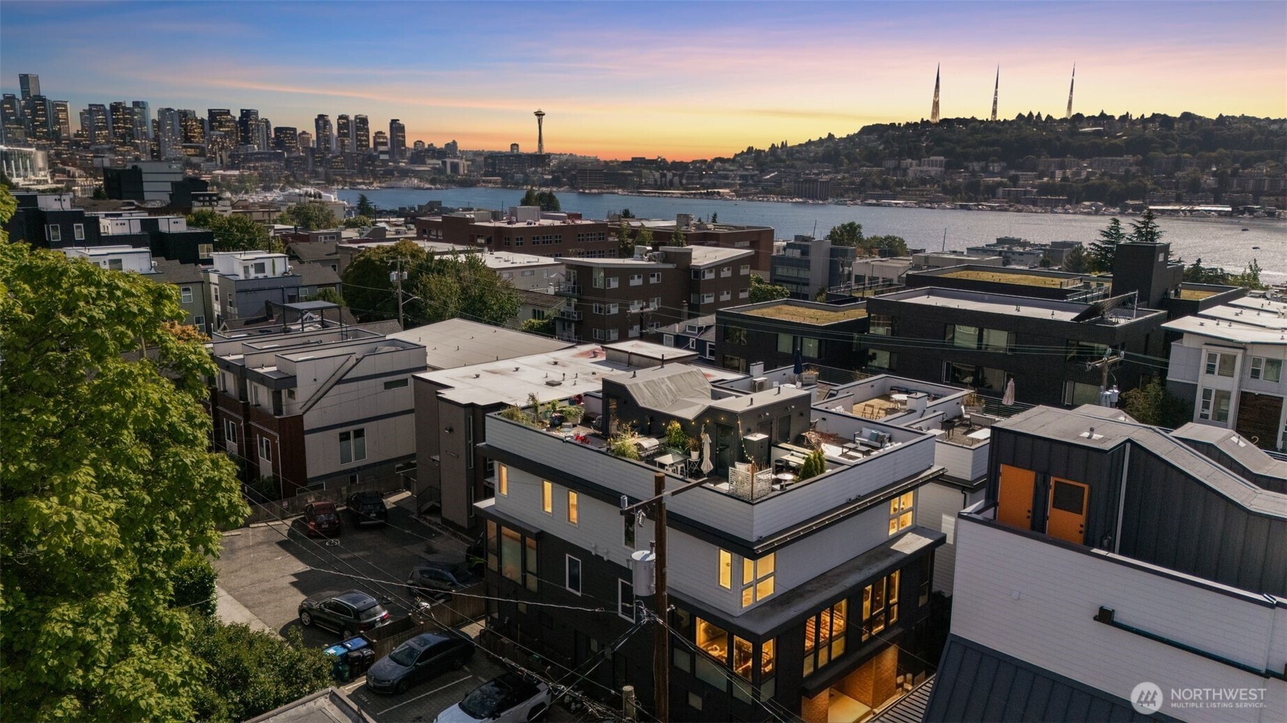 Contemporary Eastlake Seattle townhome with a spectacular private rooftop deck showcasing panoramic views of Lake Union, the Seattle skyline, and the Olympic Mountains. Offering 3 bedrooms, 1.75 baths, 1,421 square feet, and no HOA dues, this modern residence blends thoughtful design, premium finishes, and exceptional outdoor living in one of Seattle's most sought-after neighborhoods. Tucked just off the main street, this light-filled home offers a peaceful residential setting while remaining moments from Lake Union, South Lake Union, Downtown Seattle, and the University of Washington. The open-concept layout features a designer kitchen with premium appliances, mini-split heating and air conditioning, a tankless water heater, and modern finishes throughout. The expansive rooftop deck is the home's signature feature, creating an exceptional space for entertaining and relaxing. Host sunset dinners, enjoy your morning coffee, or gather with friends for unforgettable Fourth of July and New Year's Eve fireworks. Thoughtfully designed indoor and outdoor living spaces make this home feel inviting, functional, and effortlessly connected. Enjoy the best of Eastlake with easy access to Lake Union recreation, neighborhood cafés, boutique shopping, parks, South Lake Union, Downtown Seattle, I-5, SR-520, and multiple transit options. Modern, low-maintenance living with unforgettable rooftop entertaining in one of Seattle's most desirable neighborhoods.
