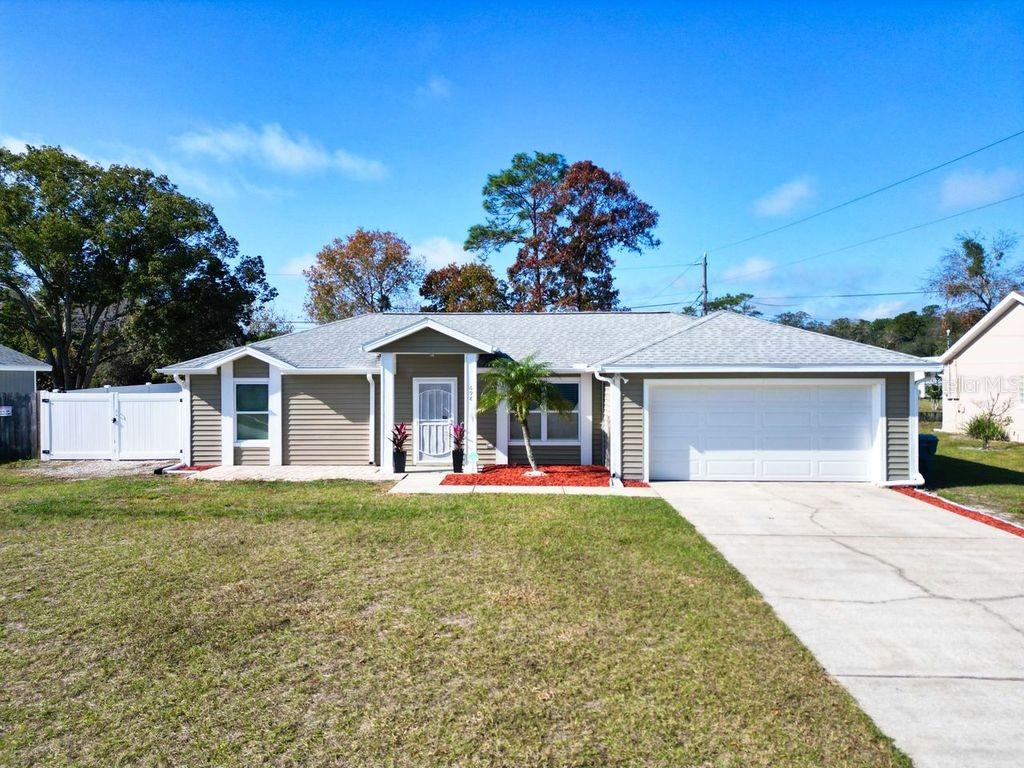 Welcome home to this charming 3-bedroom, 2-bath pool home located in a quiet Deltona neighborhood.  NO HOA! Thoughtfully renovated in 2016, major upgrades include a new roof, new windows, and new siding, providing peace of mind for years to come.  The kitchen features granite countertops, while both bathrooms have been tastefully remodeled. Additional improvements include a new insulated garage door and smart garage door opener. The Ring doorbell, washer, dryer, TVs, and living room fireplace all convey with the home.Enjoy Florida living in your screened-in heated pool, situated on an oversized lot with a new PVC privacy fence. The pool pump is only 2 years old, and the property also offers two storage sheds and a 30-AMP RV/motor home plug perfect for added convenience.  This cozy home offers space, upgrades, and functionality both inside and out. Schedule your private showing today!