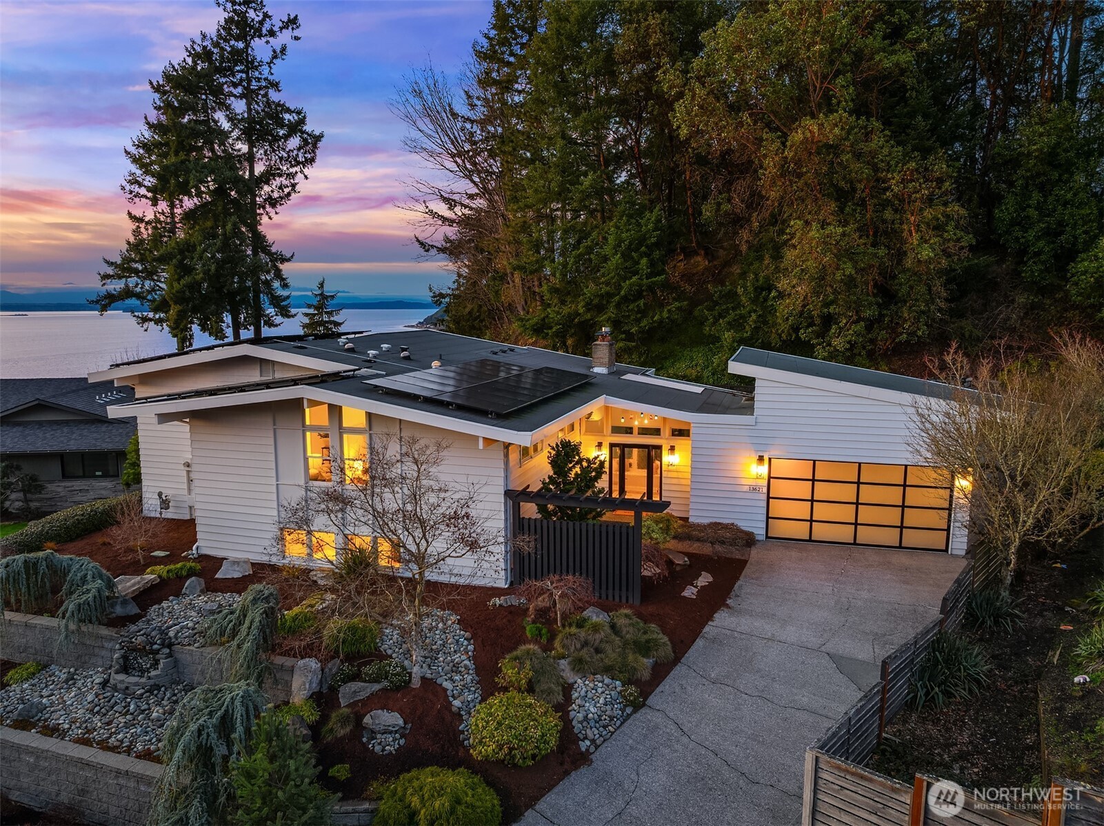 Perched high above the shoreline in coveted Seahurst/Hurstwood, this extraordinary retreat captures sweeping, unobstructed views of the Puget Sound stretching all the way to the majestic Olympic Mountains. Watch ferries glide across the water as sunsets paint the sky from your own private sanctuary. Designed for both grand entertaining and effortless everyday living, the home features a chef’s kitchen outfitted with Wolf and Sub-Zero appliances, seamlessly flowing into a covered outdoor living space complete with automated sunshades, Trex decking, a tranquil water feature, and a hot tub — creating a year-round resort experience. The luxurious primary suite is a true escape, showcasing a custom walk-in closet with its own private washer and dryer, offering elevated convenience and indulgence. Downstairs, a fully permitted ADU with private entrance and second kitchen provides exceptional flexibility for guests, multi-generational living, or income potential. Above the garage, a massive loft offers abundant storage. Commercial-grade air conditioning, solar panels, a Tesla whole-home battery system, and a whole-house water filtration system ensure comfort, efficiency, clean living, and uninterrupted power. The low-maintenance, drought-tolerant landscaping complements the eco-conscious design, allowing you to spend more time enjoying the view and less time on upkeep. A rare and distinctive offering where luxury, sustainability, and breathtaking scenery converge. Welcome home.