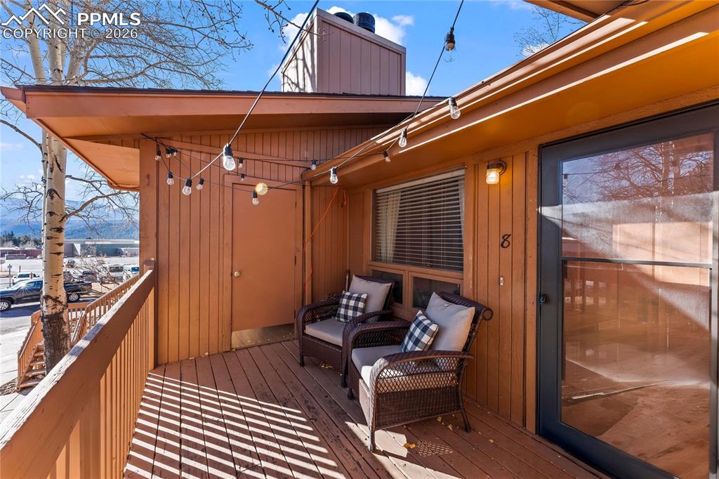 This charming condo with stunning Pikes Peak views is full of potential and ready to be transformed into a truly special retreat. Recently spruced up with fresh paint, the home feels bright, clean, and welcoming from the moment you step inside. The cozy living room features a wood-burning fireplace and flows seamlessly into a generously sized dining area, creating a warm and inviting space to relax or entertain. Just off the dining area is an efficient galley kitchen offering ample counter space, abundant cabinetry, and a pantry for added storage.The spacious primary bedroom includes a wall of closet storage and a private 3/4 bath, while the second bedroom offers a large walk-in closet and easy access to the nearby full hall bath. A conveniently located laundry closet sits just outside both bedrooms. Recent updates include newer plush carpet and a water heater, adding immediate value and comfort.Step out onto the inviting deck to enjoy sweeping views of Pikes Peak and overlook the beautifully maintained common courtyard, complete with mature aspens, grills, and picnic tables. To top it off, the detached garage for this unit is one of the larger garages in the complex—an added bonus rarely found. This condo is a fantastic opportunity to add your personal touch and create a mountain-inspired home with incredible views.