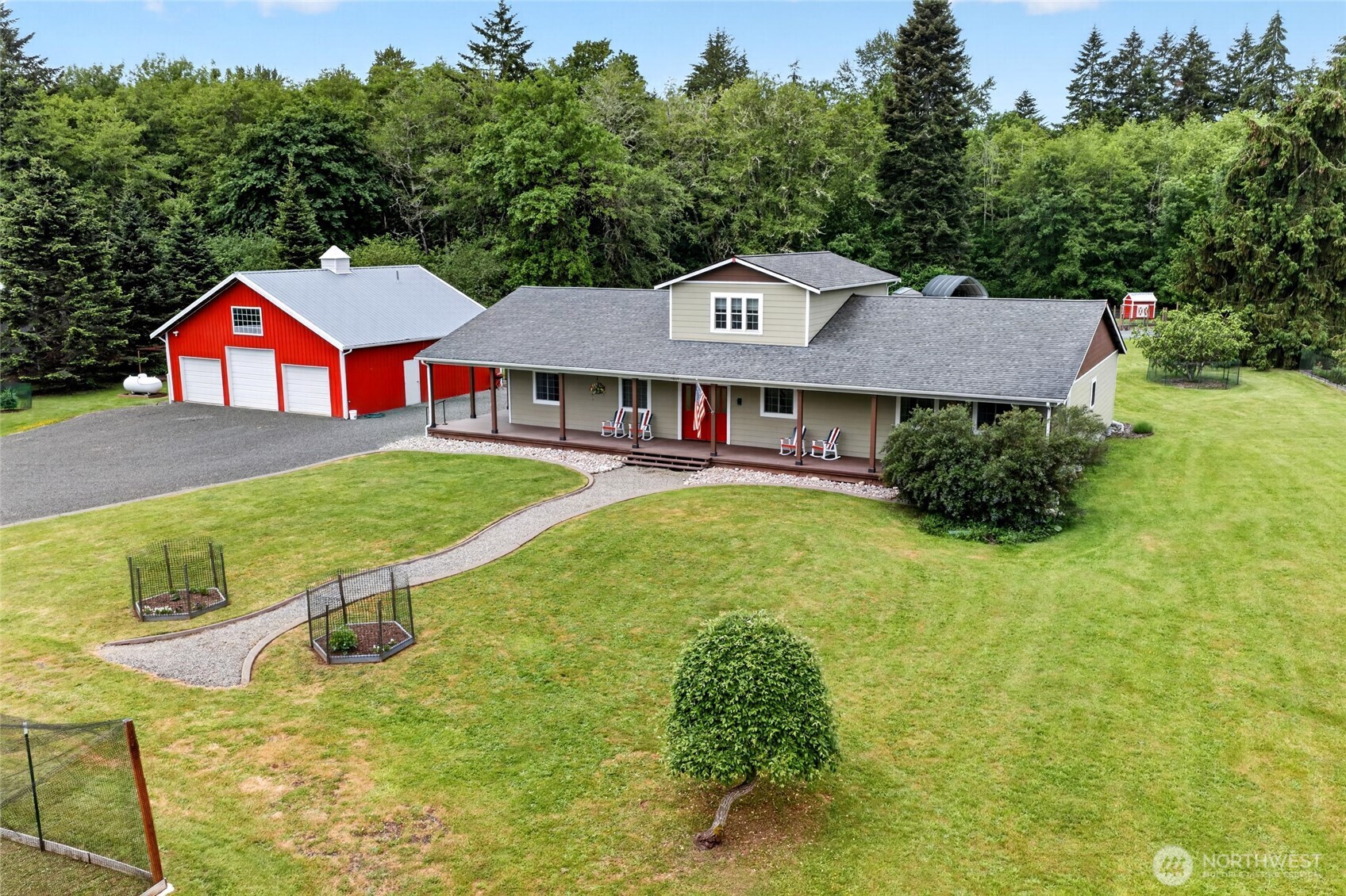 Welcome to this stunning custom one-owner home nestled on shy 5 acres of peaceful countryside. Offering nearly 3,000 sq. ft. of thoughtfully designed living space, this exceptional property blends comfort, craftsmanship, & functionality throughout. Exquisite custom concrete floors, rich knotty alder trim, and quality finishes create warmth & character at every turn.  The expansive chef’s kitchen is truly the heart of the home—designed for gatherings large or small with abundant prep space, generous storage, and beautiful views overlooking the backyard. Cozy up by the woodstove or enjoy the comfort & efficiency of radiant floor heat with hot water recirculation, keeping the home warm in winter & naturally cool in summer.  The spacious primary suite features serene backyard views, a large walk-in closet, and luxurious private bath with oversized walk-in shower. A junior primary suite with private bath, additional guest bedroom, and full guest bath offer flexibility for multigenerational living or guests. Additional spaces include a private office, sitting room or study, & expansive upstairs bonus room-perfect for hobbies, recreation or gatherings.   Outdoor living shines with a wraparound deck, large patio for entertaining, soothing bubbling rock water feature, raised garden beds, greenhouse, chicken coop, mature blueberry bushes, massive firepit, and an expansive 3-bay shop for all your toys and projects. A truly special property offering privacy, lifestyle, & room to thrive.