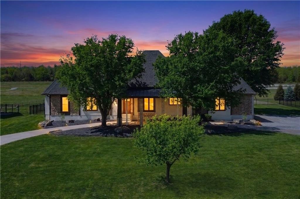 Welcome to a rare opportunity on Lake Drive, one of Lakewood’s most desirable streets in Lee’s Summit. This exceptional property offers what is increasingly hard to find - a full, flat acre lot paired with space, privacy, and lifestyle-driven design, making it a true forever family home.The outdoor setting is nothing short of remarkable. The massive, fully fenced backyard provides direct access to green space, creating a peaceful, park-like backdrop. Designed for both entertaining and everyday enjoyment, the property features expansive concrete patios, a private backyard pavilion, and all-new landscaping that enhances both beauty and usability. A grand circular drive delivers impressive curb appeal and ample parking, while the RV-height garage door offers exceptional versatility for recreational vehicles, boats, or additional storage. Inside, the home offers over 5,000 square feet of living space, highlighted by a massive living room that serves as the heart of the home—perfect for hosting, relaxing, and creating lasting memories.With rare acreage, a premier Lakewood location, and a layout designed for long-term living, this property represents a unique opportunity to enjoy space, privacy, and community without compromise. This is the lifestyle upgrade you’ve been waiting for!