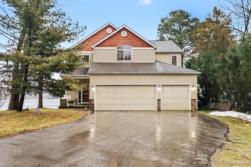 Enjoy spectacular all-sports lakefront living on Lake Oakland, connecting directly to Woodhull Lake, offering miles of boating, recreation, & waterfront enjoyment from your private shoreline. Positioned on what is arguably one of the best settings on the lake, this property sits on a peninsula-like perch capturing panoramic water views in multiple directions & unforgettable sunrises. Sited on a rare .54-acre parcel on the lake’s Gold Coast, the property provides abundant parking & space for boat storage, a highly desirable feature rarely found on established lakefront homes. This home was completely rebuilt in 2007, offering the benefits of a newer build on one of Oakland County’s most sought-after all-sports lakes. Inside, a dramatic two-story great room with fireplace & expansive windows showcases the lake as the focal point of the home, filling the space with natural light & breathtaking views year-round. The open layout flows seamlessly into the kitchen & dining area featuring granite countertops, stainless appliances, & a large center island, ideal for entertaining or everyday living. Sliding doors lead directly to the expansive TREX deck overlooking the lake. Upstairs, the primary suite offers vaulted ceilings & stunning lake views, along with a beautifully renovated spa-inspired bath featuring a freestanding soaking tub, glass-enclosed shower, & dual vanity. A W/I closet & loft overlooking the great room add functionality & architectural character. Recent improvements totaling $155,000 over the past two years include a new stone boulder retaining wall, full-width lakeside deck spanning all 60 feet of frontage, new dock, and TREX deck, creating an exceptional shoreline environment ideal for boating, swimming, & entertaining. Whether enjoying fireworks over the water, boating across Lake Oakland & Woodhull Lake, or relaxing with panoramic sunrises, this property offers a rare opportunity to enjoy one of the most exceptional lakefront settings in the area IDRBNG