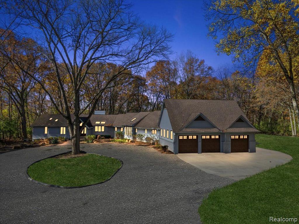 Welcome to your exquisite sanctuary!  A luxurious 5-bedroom, 6.1-bath estate nestled on a breathtaking 2.82-acre haven. This remarkable property is a true retreat, where panoramic views are elegantly framed by grand floor-to-ceiling windows, flooding the interior with natural light and creating an inviting atmosphere throughout. As you enter the magnificent great room, you are greeted by soaring ceilings and a striking fireplace, setting the tone for an ambiance of refined elegance and comfort. The gourmet kitchen, designed for the culinary enthusiast, boasts premium appliances and sophisticated finishes that elevate every culinary endeavor into a masterpiece. Indulge in the opulent primary suite, your personal oasis, complete with a spa-like bath and an expansive walk-in closet, tailored for a lifestyle of luxury. Notably, both the primary walk-in closet and the cedar closet in the finished lower level feature secure key-access safe rooms, equipped with hookups for security cameras and monitors, ensuring peace of mind. The finished lower level is a haven for entertainment, featuring a state-of-the-art movie theater, a chic wet bar, and a full bath.  Perfectly designed for lavish gatherings or intimate evenings at home.
Outside, the expansive grounds offer a serene canvas for outdoor leisure, enveloped by tranquil woods that guarantee your privacy and tranquility. This exceptional estate masterfully combines modern luxury with the serene beauty of nature, providing the ultimate retreat while remaining conveniently close to top-rated schools, upscale shopping, and major thoroughfares. Don't miss your chance to experience this extraordinary gem, where sophistication meets peaceful living.