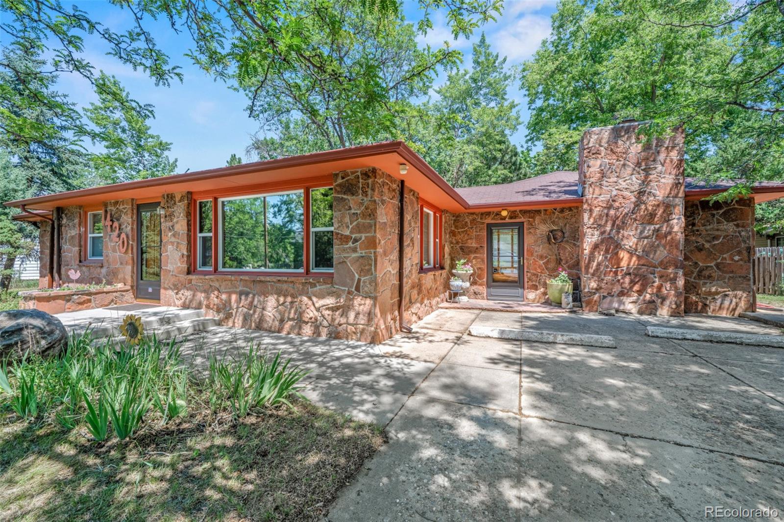 Welcome home to 1420 Cherryvale Road, where timeless Mid-Century Modern design meets the Boulder lifestyle. Nestled on just under one acre, this beautifully maintained 1952 flagstone ranch offers endless possibilities—from an artist's retreat to a homesteader's dream.Enjoy the best of Boulder living with the Flatirons, Pearl Street, and the University of Colorado just minutes away. World-class hiking and biking trails are nearby, while Denver International Airport is less than an hour away.Inside, you'll find the craftsmanship of a bygone era with original hardwood floors, smooth lath-and-plaster walls, elegant coved ceilings, and abundant natural light. Modern updates include a new boiler and energy-efficient mini-split systems for year-round comfort.The original garage has been transformed into a private suite with a spacious den, wet bar, large closet, and separate entrance, making it ideal for a home office, guest suite, creative studio, or potential short-term rental.While located in Boulder County, the property has recently been connected to City of Boulder water and sewer services, providing the convenience of municipal utilities while maintaining a spacious country setting. A partial share of East Boulder Ditch water rights is also available for purchase.The expansive backyard, with separate access from the back, is ready for your vision, with room for extensive gardens, hobby farming, outdoor entertaining, or simply enjoying Colorado's natural beauty. A detached two-car garage with 220-volt power is perfect for projects or workshop space, and two additional storage sheds provide plenty of room for equipment and outdoor gear.Boulder County also allows the potential for an Accessory Dwelling Unit (ADU), subject to county approval, offering even more flexibility for future living or income opportunities.This is more than a home, it's an opportunity to create the Colorado lifestyle you've been dreaming of.