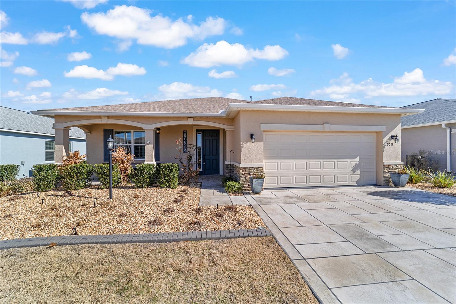 PRIVATE LOT | TURN-KEY OPTION | SHOWS LIKE A MODELSituated on a premium private lot, this 2022-built Wisteria shows like a model and offers 2 bedrooms, 2 bathrooms, a flex room with French doors, and a 2-car garage. The gourmet kitchen is a baker's delight, featuring a spacious island with specialty millwork, quartz countertops, gray subway tile backsplash, white cabinetry with crown molding, a walk-in pantry, and stainless-steel appliances including a built-in oven/microwave and gas cooktop. The primary suite is a true retreat with two walk-in closets and a stunning en suite bath showcasing dual vessel sinks and an oversized walk-in shower with upgraded tile. Throughout the home you'll find luxury vinyl plank flooring (with carpet in the guest bedroom and flex room), plantation-style shutter blinds, tray ceilings, crown molding, extra recessed lighting, and designer fans and fixtures. Outdoor living shines with a northeastern-facing enclosed lanai perfect for year-round enjoyment, plus a large paver patio pre-plumbed for a gas grill, ideal for entertaining. Enhanced curb appeal includes curbed landscape beds and a recently added stamp-crete driveway. Additional upgrades include a water softener and an insulated garage door. As an added bonus, this home can be offered turn-key. Weybourne Landing features fee-simple ownership, low HOA fees, and private amenities including a swimming pool, pickleball, mini-golf, fitness center, clubhouse, and curbside waste collection. Located within On Top of the World, Ocala's premier 55+ active adult golf resort community, residents enjoy golf-cart access to shopping, dining, entertainment, healthcare, and more.