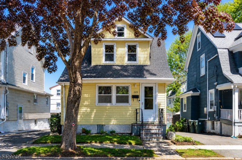 Welcome to 329 Lindsley Avenue - a thoughtfully updated 3-bedroom, 2-bath home offering flexible living space, charming original character, and an ideal South Orange location just under a mile from the Midtown Direct train and vibrate South Orange Village. The renovated kitchen features granite countertops, stainless steel appliances, abundant cabinet storage, and exposed brick accents, flowing seamlessly into the dining room and oversized deck for easy everyday living and entertaining. Sun-filled living and dining spaces balance warmth and functionality, while the enclosed front porch offers the perfect bonus space for a home office, reading nook, or morning coffee retreat. Upstairs, three comfortable bedrooms are complemented by a finished third level accessed through one of the bedrooms - ideal as a playroom, creative studio, guest space, or additional work-from-home setup. The finished basement provides flexible recreation or hangout space, along with a full bath and additional storage. Outside, the expansive deck overlooks the backyard and creates a true extension of the home for dining, entertaining, or relaxing outdoors. Located on a tree-lined street near South Orange Village shops, restaurants, parks, and NJ Transit service to NYC, this home offers the combination of character, space, and convenience buyers are searching for. Welcome home.