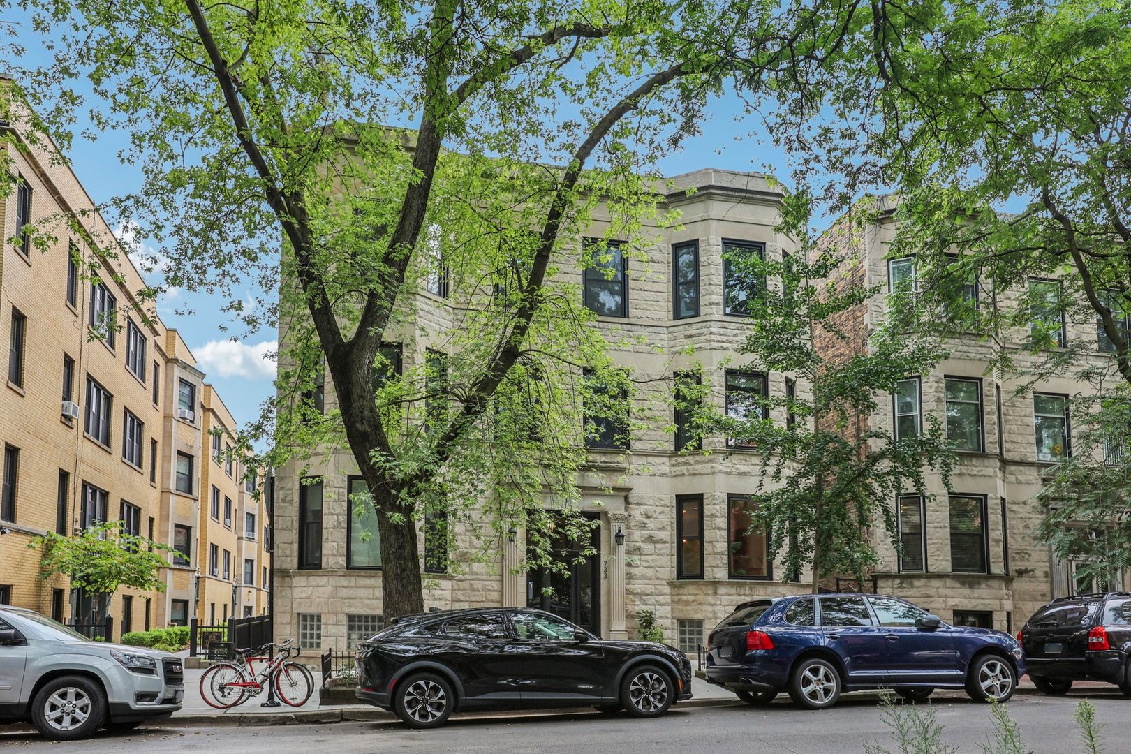 Step into 733 W Briar Pl #1W, a stunning 3-bedroom, 1st-floor residence where vintage Chicago charm meets modern, high-end living. Flooded with natural light through Imperial LS High Performance windows-installed in 2010 and designed to open inward for effortless cleaning-this home glows with original hardwood floors, exposed brick walls, and custom built-ins that create an inviting, timeless atmosphere. The heart of the home is a showpiece kitchen, fully reimagined in December 2022 with solid wood, dovetail soft-close cabinetry, sleek countertops, built-in organizers, pull-out trash and recycling, and an Aquasana water filtration system, complemented by a full suite of Frigidaire appliances. Year-round comfort is ensured by a state-of-the-art Trane furnace and central A/C installed in 2021, both backed by long-term warranties for peace of mind. Enjoy the convenience of in-unit laundry, unwind on your private deck, and savor the tranquility of a large, quiet shared backyard with no alley access. Located in the heart of East Lakeview, this home places you just steps from Lake Michigan, the CTA Red, Brown, and Purple Lines, and some of the city's best dining, shopping, and entertainment-perfectly blending historic charm with a vibrant, walkable lifestyle.