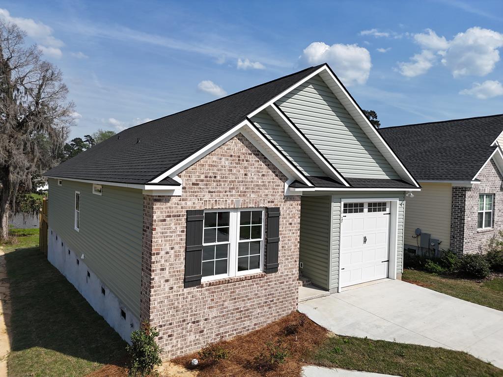 NOW COMPLETE! This home was listed during construction available for presale but is now move-in ready! Sit on your covered back porch with adjoining wood deck and watch the fish jump and the ducks glide in the lovely Lake. Spacious single family 1600+ sq ft. home in the desirable 55 and older Huntington Pointe Subdivision. 3 bedrooms and two baths with an enormous great room with vaulted ceiling and spacious bar separating the large kitchen filled with cabinets. Enclosed sunroom. Garage for safety and privacy. Under deck and house is storage and basement. Lot is beautifully landscape leading to the lake. Lots of quality extras inside stunning millworker in this completed new construction home. Many want this quiet area but desire a single family home, here it is!