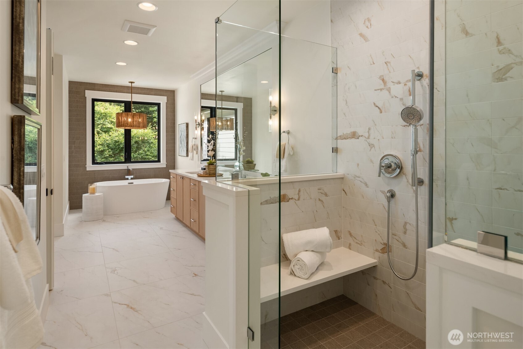 Spacious bath with a glass-enclosed shower.