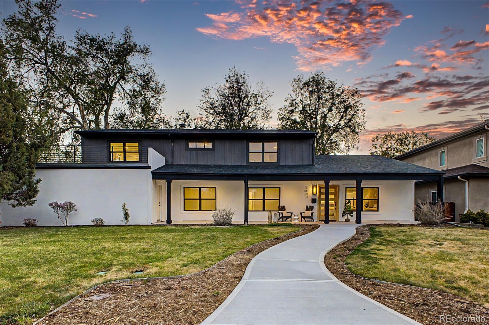 A full-scale renovation of a 1950s University Hills home, thoughtfully reimagined with 3,515 square feet, 4 bedrooms, 3 baths, and a level of finish and design rarely found in the area.The main level is anchored by a striking kitchen and living space, where a navy island with quartz countertops, custom cabinetry, and high-end appliances flows seamlessly into the dining area. A dramatic coffered ceiling creates a defined yet connected space, while a concealed-entry walk-in pantry, hidden behind custom cabinetry, adds both function and a refined design element. Expansive glass doors open to the backyard, creating a true indoor-outdoor connection.The primary suite spans the full width of the upper level, offering generous proportions, a dedicated sitting area, and direct access to a private deck. The ensuite bath features a freestanding soaking tub, glass-enclosed shower, dual vanities, and refined material selections, complemented by a custom walk-in closet system.Three additional bedrooms provide flexibility for guests, office space, or long-term living needs, while an upper-level loft/office offers a separate, versatile area for work or relaxation.Enjoy outdoor living with a covered patio designed for relaxed, shaded seating and a separate open-air patio ideal for dining and entertaining, all set within a private backyard with professionally updated landscaping and drip irrigation. Extensive upgrades include new windows, roof, Trex decking with custom metal railing, multi-zone mini-split HVAC, updated plumbing and electrical components, a new water heater, and designer lighting throughout. A three-car garage adds significant functionality and further enhances the overall scale of the home.Walk to King Soopers, Michael's, Marshalls, Target, Ross-Univeristy Hills Library, across the street is the Eisenhower Recreational Center, with Pickleball and tennis courts, pool, a gym and go to play golf at Wellshire Golf Course.