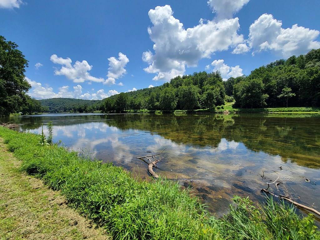 Your Dream Recreational River Lot Awaits! Discover one of the most spacious recreational lots on the New River in Grayson County, boasting over 120 feet of pristine river frontage—equivalent to purchasing three traditional lots with 40-foot frontage. This rare gem features near level topography, making it the perfect spot for your riverside retreat. Bring your kayaks and tubes and embark on a fun-filled float down to the State boat landing, just 1.4 miles away!  Close enough to turn around and do it again.  Whether you seek adventure or tranquility, this property offers the best of both worlds. Enjoy peace of mind with some covenants and restrictions in place, ensuring a well-maintained community. Don't miss your chance to own a slice of paradise on the New River—a fantastic place to relax, unwind, and create unforgettable memories!