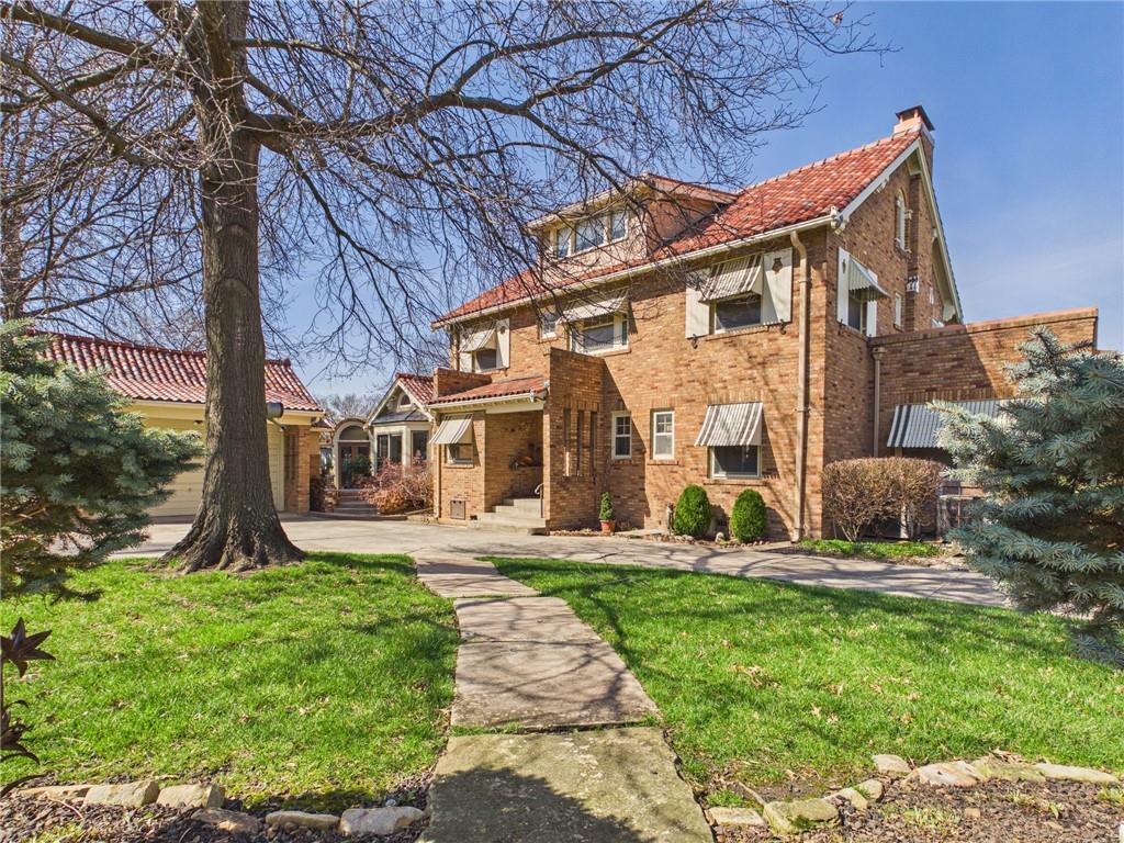 A Heritage Estate: 1925 Brick Masterpiece Reimagined1.08-Acre In-Town Sanctuary | Architectural Spa Retreat | Bespoke LuxuryExperience a rare blend of Roaring Twenties elegance and affluent modern living. This meticulously restored 1925 brick estate, situated on a sprawling 1.08-acre private park in the heart of town, is a curated lifestyle. Transformed by a visionary owner, every inch of this 3,823 sq. ft. manor reflects uncompromising quality and architectural artistry.Architectural Synergy & Interior GrandeurThe residence honors its historic roots with a classic red clay tile roof and Spanish-Eclectic accents, while the interior is a contemporary masterpiece.• Voluminous Living: Soaring vaulted ceilings with exposed timber beams and a sleek linear fireplace create a grand atmosphere.• Light as Art: Ornate leaded glass, arched transoms, and expansive bays flood the home with natural light.• The Collector’s Palette: Rich custom millwork and a seamless flow of premium hardwood and tile (no carpet) underscore a clean, high-end aesthetic.• Versatile Living: 3 spacious bedrooms and 2.5 baths are complemented by a fully finished attic and basement, ideal for a private gym or media room.The Private Oasis & OutbuildingsThe exterior is an entertainer’s paradise, designed for total privacy.• The Spa Pavilion: A "one-of-one" feature, this custom indoor patio and spa showcases Art Deco-inspired lines and a signature circular window for year-round relaxation.• Manicured Grounds: Over an acre of immaculate landscaping, stone-bordered beds, mature evergreens, and a charming gazebo.• Automotive Excellence: A sprawling concrete drive leads to an oversized 3-car garage plus a 2-car carport, perfect for a premium vehicle collection.Enjoy the ultimate luxury: Space without sacrifice. This estate offers the rare tranquility while remaining centrally located. You are moments from the town, yet worlds away in your own private sanctuary.