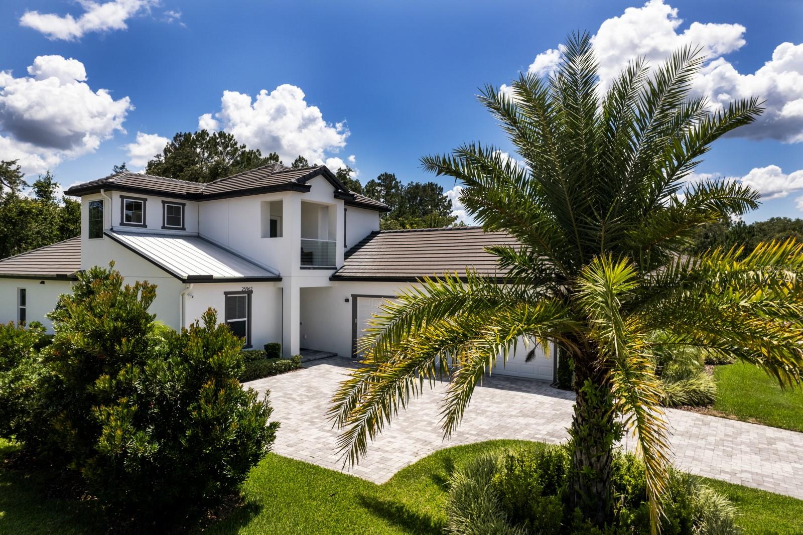 Luxurious, modern, and simply beautiful, this Redtail estate home offers refined living within one of Central Florida’s most sought-after gated golf communities. Social Membership privileges, granting access to the clubhouse restaurant, tennis courts, fitness center, and community pool—all just a short walk from your front door. Designed with an open, spacious layout, this like-new home is ideal for both everyday comfort and entertaining. The kitchen, dining, and living areas blend seamlessly and extend into the lanai, creating a true indoor–outdoor lifestyle. The master retreat is a serene escape at the end of the day, featuring a stunning ensuite with double sinks, a large walk-in shower, free-standing soaking tub, and his & hers walk-in closets. A dedicated office near the front of the home provides excellent privacy for working remotely. Perfect for a teenager, in-laws, or long-term guests, the upstairs level offers its own secluded living space with a flex room (office/workout area), generously sized bedroom, full bathroom, and a private balcony. Two additional well-sized bedrooms and a full bath are located on the main floor, along with a separate powder room for guests. A true focal point of the home, the kitchen features:Massive quartz waterfall island, Extensive quartz counter surfaces, Cooktop and stainless-steel appliances, Custom soft-close cabinetry, A secret walk-in pantry with exceptional storage. Whole-home interior and exterior water filtration system. The lanai is a masterpiece of design—fully screened, beautifully paved, and perfectly integrated with the main living areas to bring the outdoors in. The oversized 3-car garage easily accommodates vehicles, tools, and additional storage. Light on traffic yet incredibly convenient: Quick access to 429 for commuting to Orlando or Sanford, Less than 15 minutes to Mount Dora or Eustis, Close to shopping, medical centers, restaurants, festivals, parks, schools, and more. This exceptional home in an acclaimed golf community offers luxury, comfort, and convenience in one perfect package. Schedule your private viewing today.l